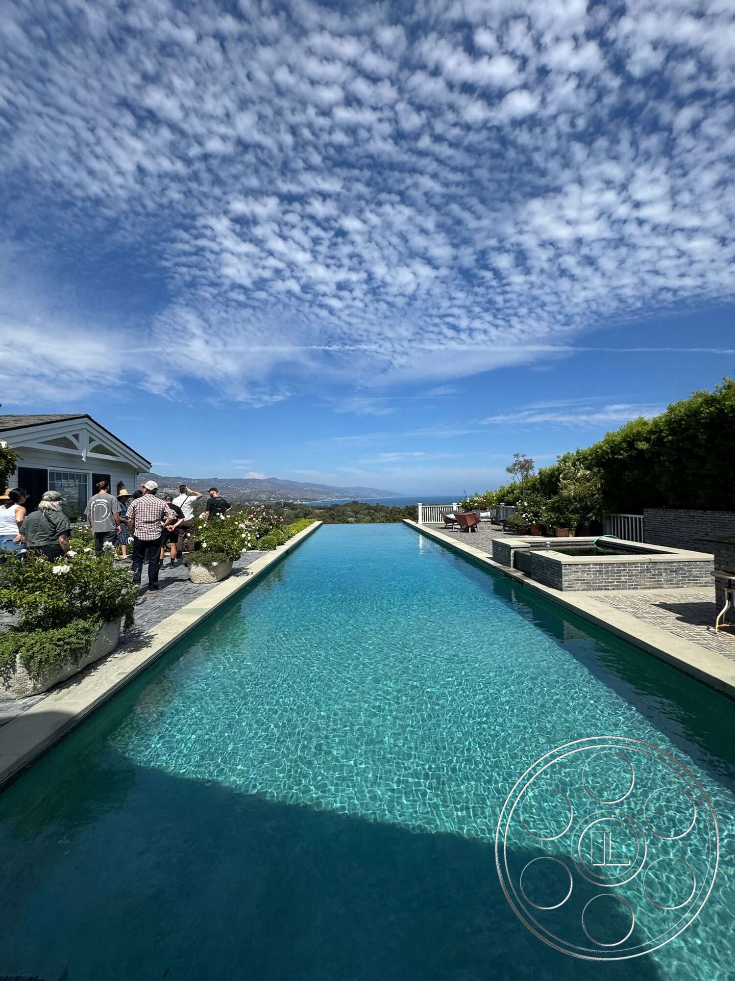 Americana 113 - exterior, modern architecture, infinity pool, skyline view, stone pool deck, concrete patio flooring, landscaped garden areas, white wooden railings