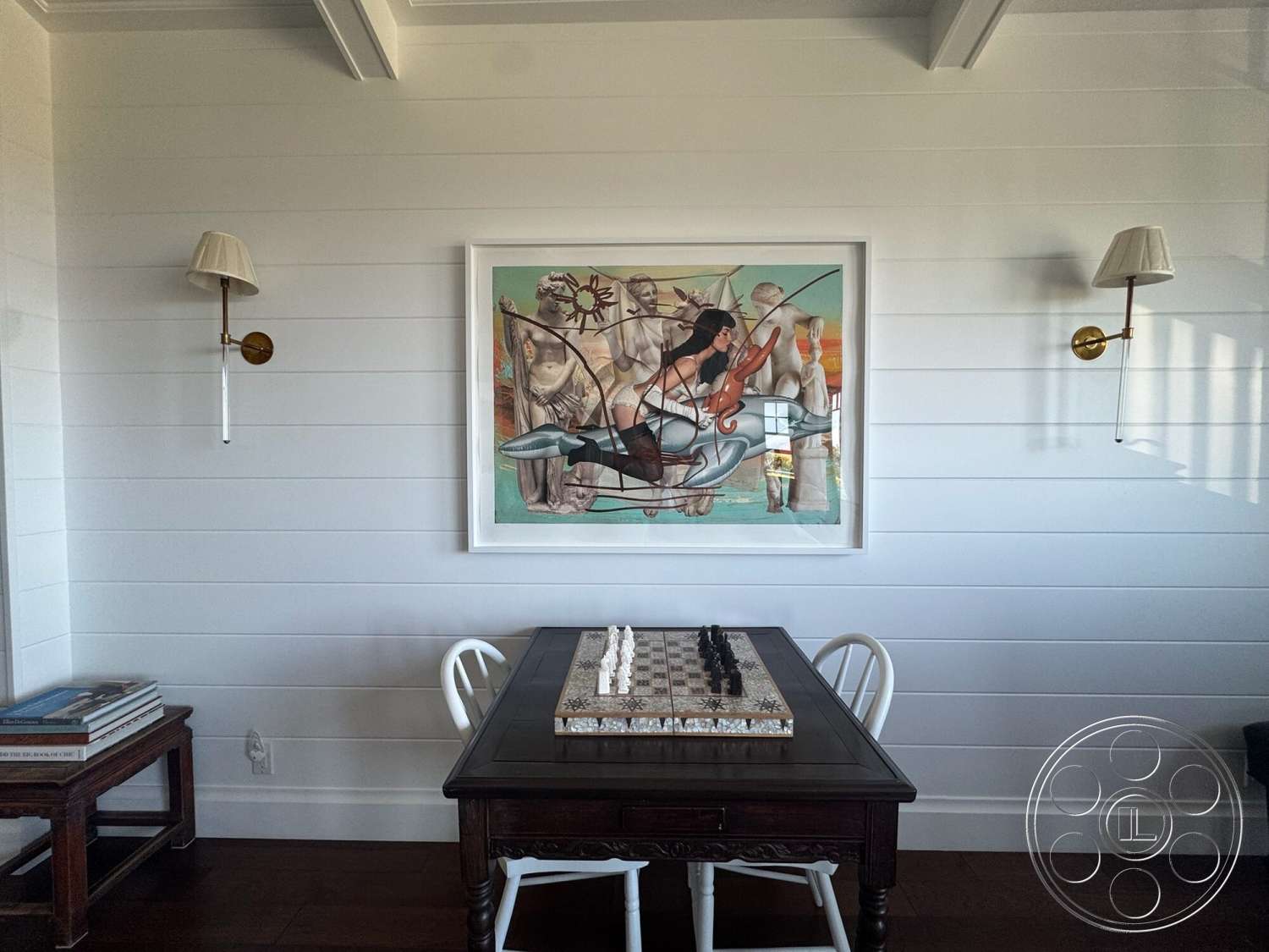 Americana 113 - abstract wall art, modern lighting fixtures, dark hardwood flooring, exposed ceiling beams, traditional wooden dining table, gold wall sconces, painted shiplap walls, white wooden dining chairs, decorative chess set