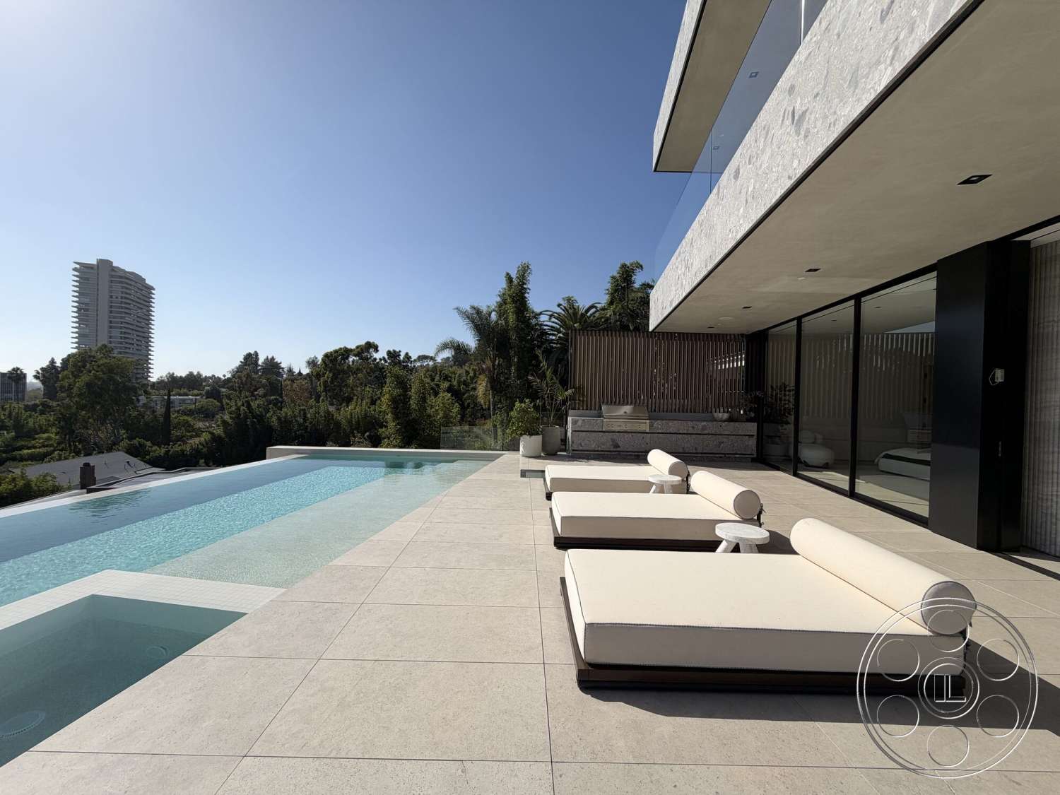 Modern 532 - exterior, landscaped garden, textured stone wall, glass sliding doors, panoramic city view, infinity pool, modern lounge chairs, concrete patio flooring, minimalist architectural style, horizontal wooden slat fence, wooden deck planters