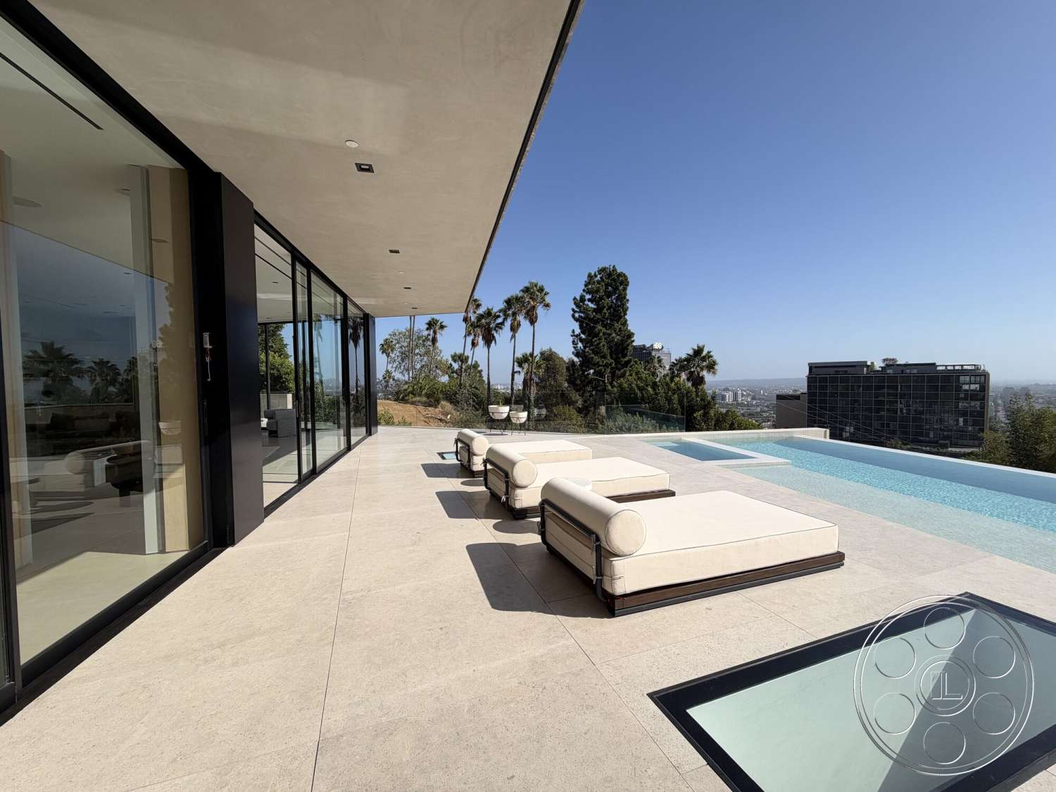 Modern 532 - exterior, landscaped garden view, open-air design, city skyline view, infinity pool, tropical palm trees, modern outdoor lounge area, stone patio flooring, floor-to-ceiling glass walls, concrete overhang