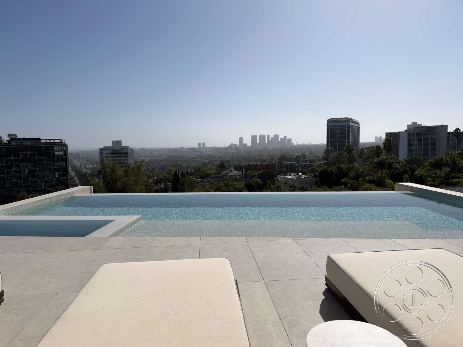 Modern 532 - exterior, modern architecture, glass railing, outdoor living space, city skyline view, sun loungers, infinity pool, concrete patio floor, tile pool deck, gentle slope landscaping