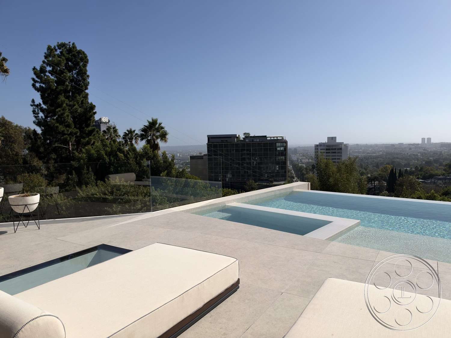 Modern 532 - exterior, modern architecture, city skyline view, infinity pool, concrete patio flooring, glass pool edge, minimalist outdoor lounge area, rectangular pool design, palm trees in surrounding landscape, floor-to-ceiling glass railings