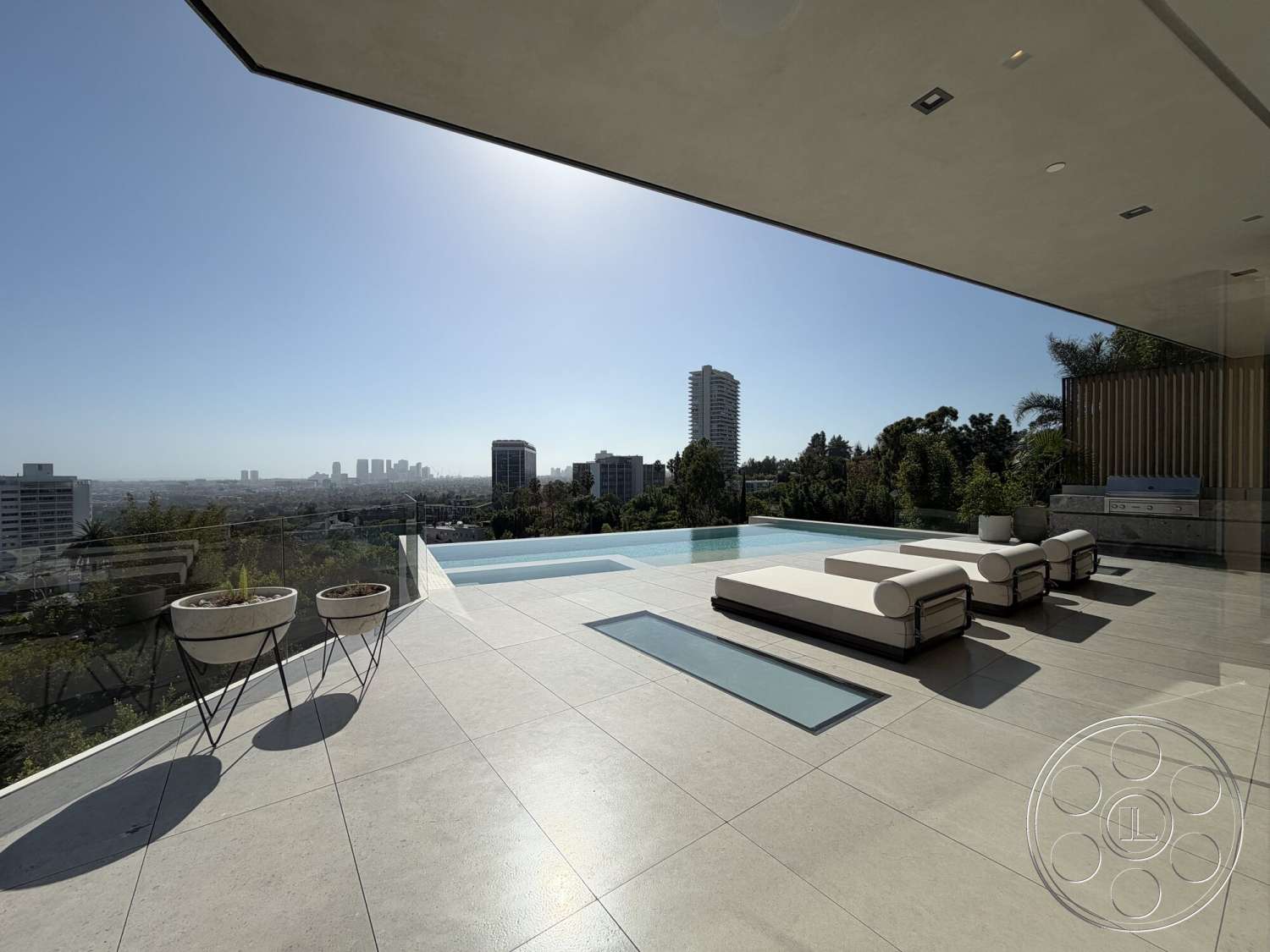Modern 532 - glass railing, floor-to-ceiling windows, open-air design, city skyline view, infinity pool, large sliding glass doors, planter pots, modern lounge chairs, concrete patio flooring, minimalist architectural style, stone outdoor kitchen, south-facing exposure