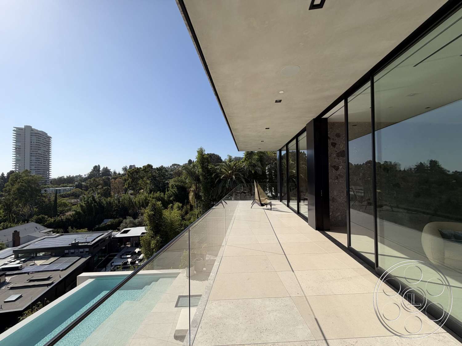 Modern 532 - exterior, landscaped greenery, modern architectural style, city skyline view, stone feature wall, concrete patio flooring, floor-to-ceiling glass windows, rectangular infinity pool, urban backyard setting, open outdoor terrace, ceiling overhang