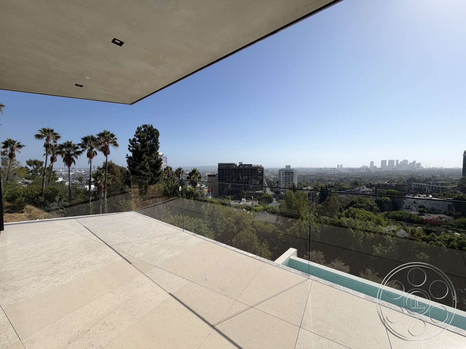 Modern 532 - exterior, surrounding greenery, modern architectural style, open-air design, city skyline view, rectangular layout, stone patio flooring, floor-to-ceiling glass railing, gazeebo-style overhang