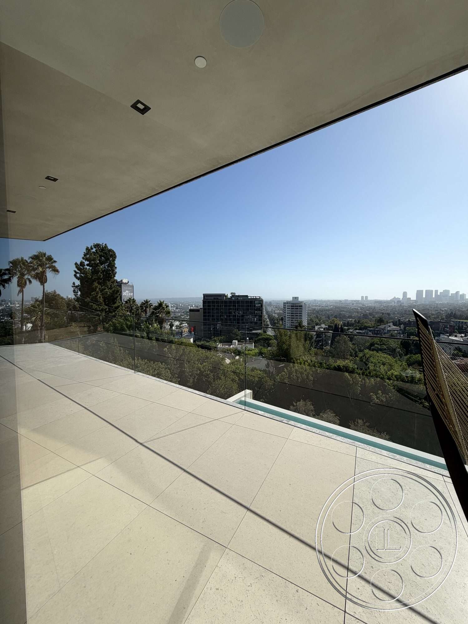 Modern 532 - exterior, glass railing, modern architectural style, open outdoor space, panoramic city skyline view, concrete balcony flooring, overhanging concrete ceiling, landscaped greenery below