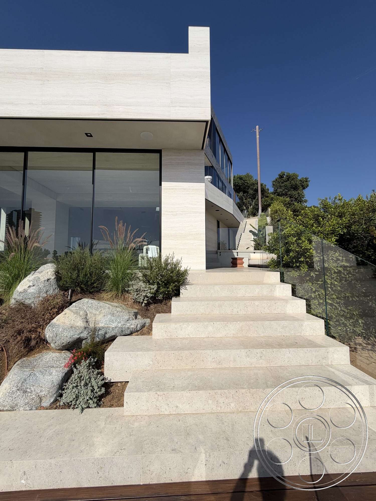 Modern 532 - exterior, modern architecture, minimalist design, large glass windows, surrounding greenery, stone pathway, open outdoor space, contemporary home, succulent garden, hillside location, flat roof design, natural stone landscaping, travertine staircase steps, vertical wooden beams, seamless glass railing