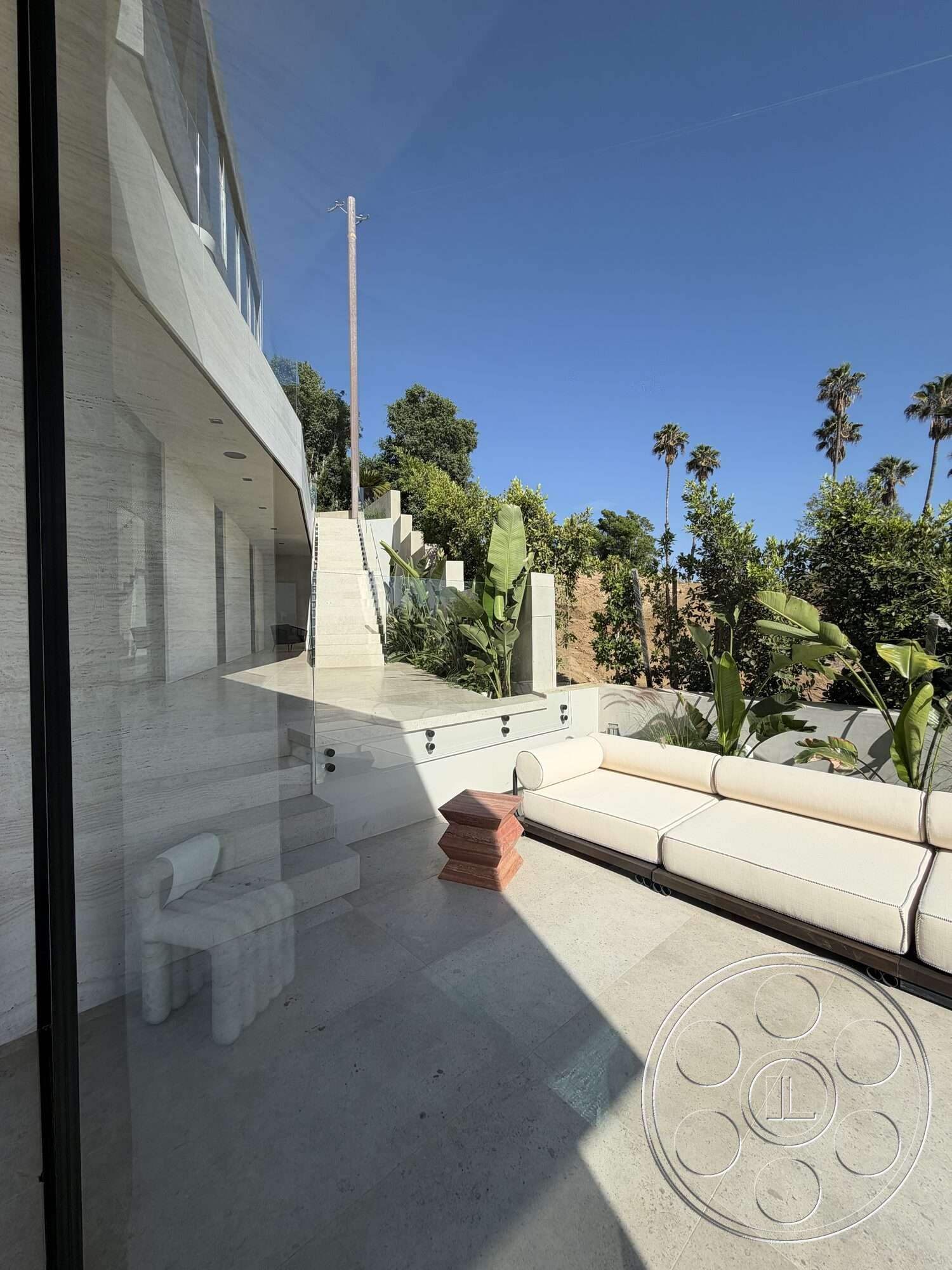 Modern 532 - natural light, exterior, minimalist design elements, concrete steps, lush tropical landscaping, textured stone walls, glass partition walls, modern outdoor seating area, stone patio flooring, palm tree surroundings, horizontal glass windows, stairway to terrace