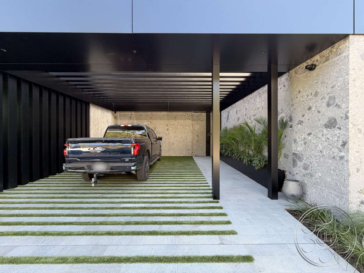 Modern 532 - exterior, vertical wood paneling, flat roof design, contemporary garage space, polished concrete driveway, stone facade wall, metal beams roof structure, artificial grass turf, linear landscaping layout, sleek modern aesthetic, flowering plants border, architectural feature planter