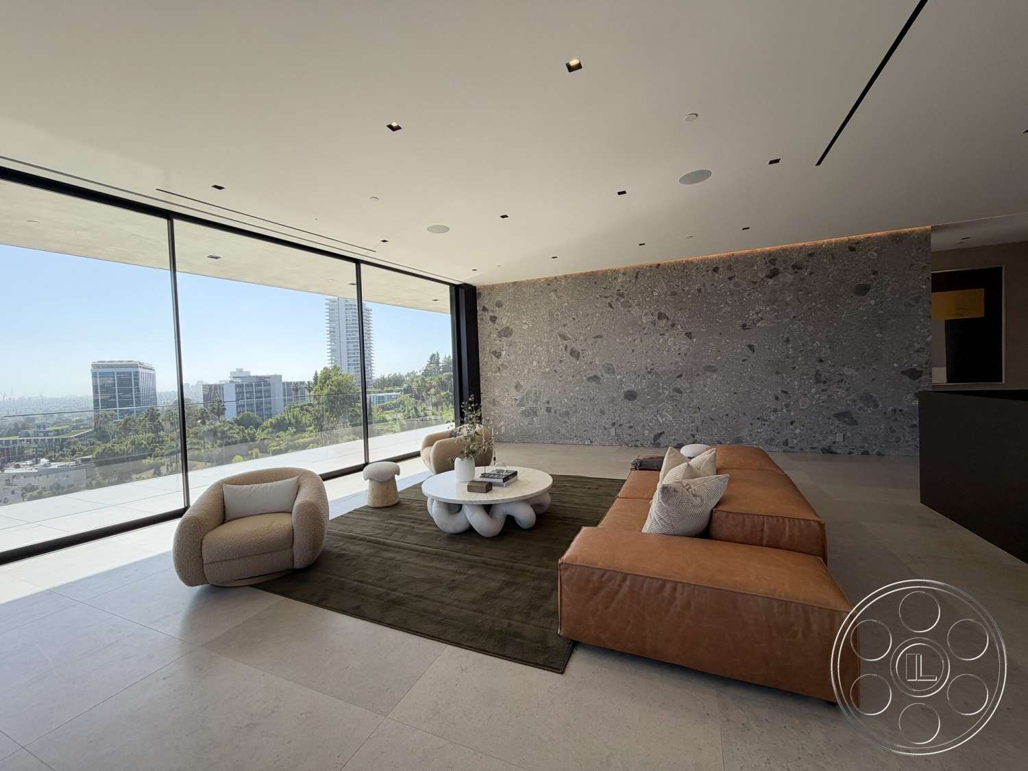 Modern 532 - minimalist design, stone accent wall, round coffee table, open floor plan, floor-to-ceiling windows, neutral area rug, urban skyline view, recessed ceiling lighting, modern sectional sofa, light-colored marble flooring, textured beige armchairs
