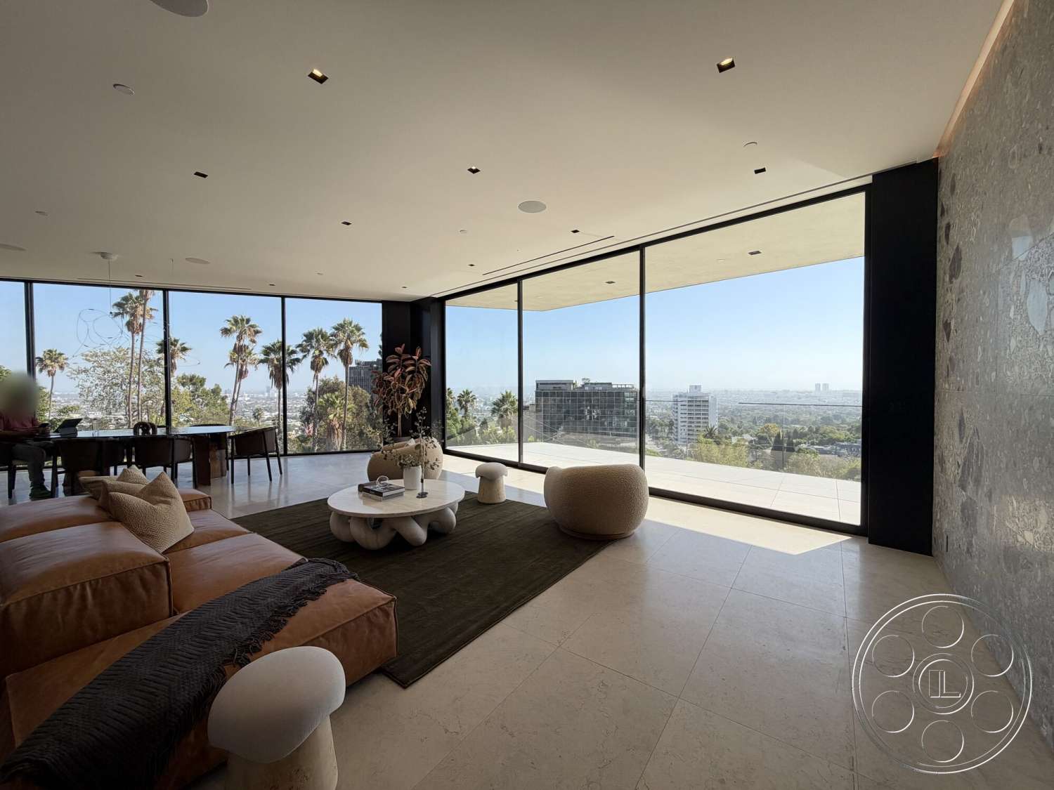 Modern 532 - minimalist decor, neutral color palette, recessed lighting, open floor plan, area rug, exposed concrete walls, modern coffee table, sculptural seating, floor-to-ceiling windows, urban skyline view, large sliding glass doors, palm tree view, leather sectional sofa, stone tile flooring, accent wall