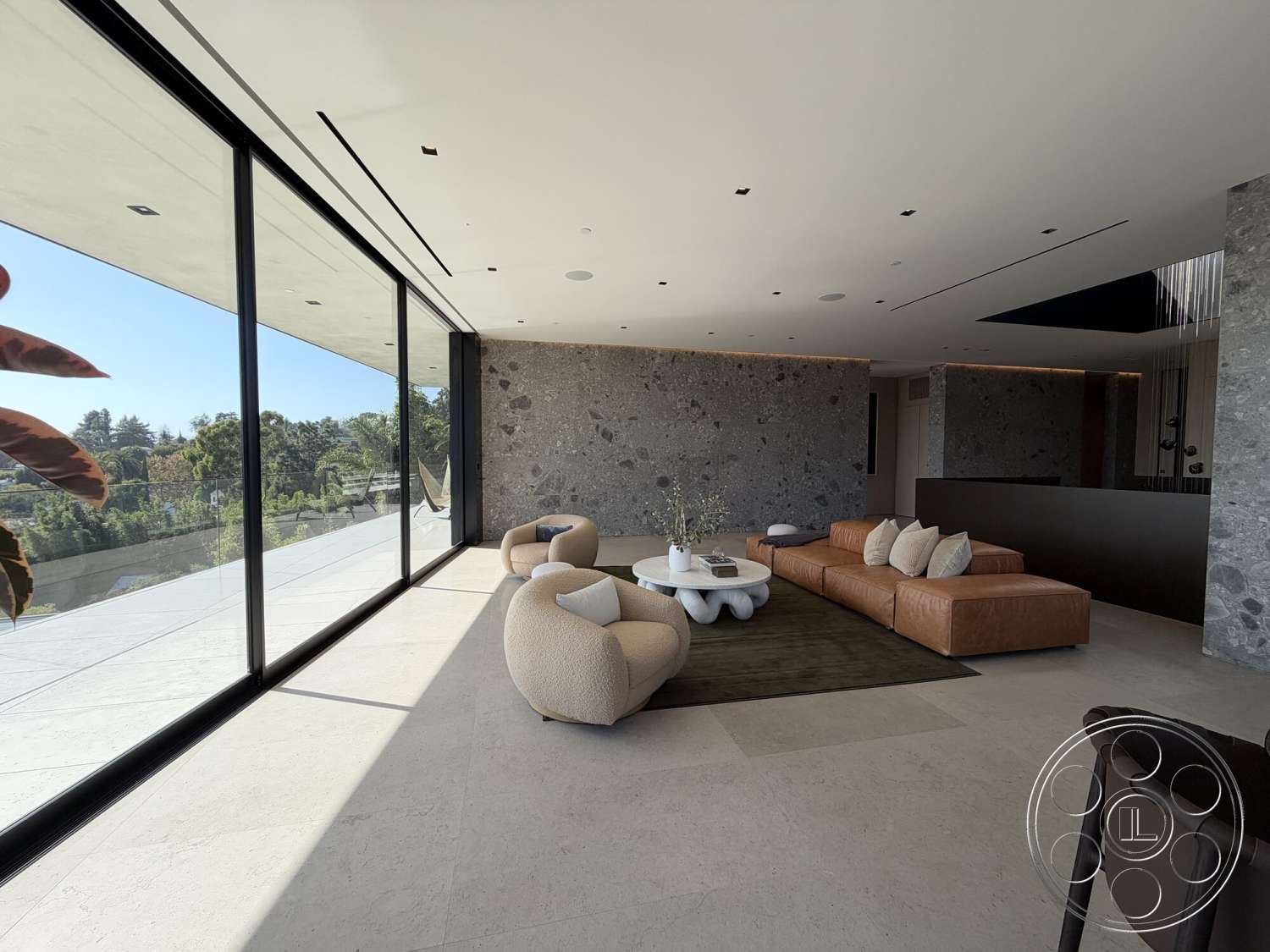 Modern 532 - floor-to-ceiling windows, soft area rug, concrete ceiling, leather sectional sofa, textured stone feature wall, linear recessed lighting, porcelain tile flooring, minimalist modern design, large rectangular coffee table, round accent chair