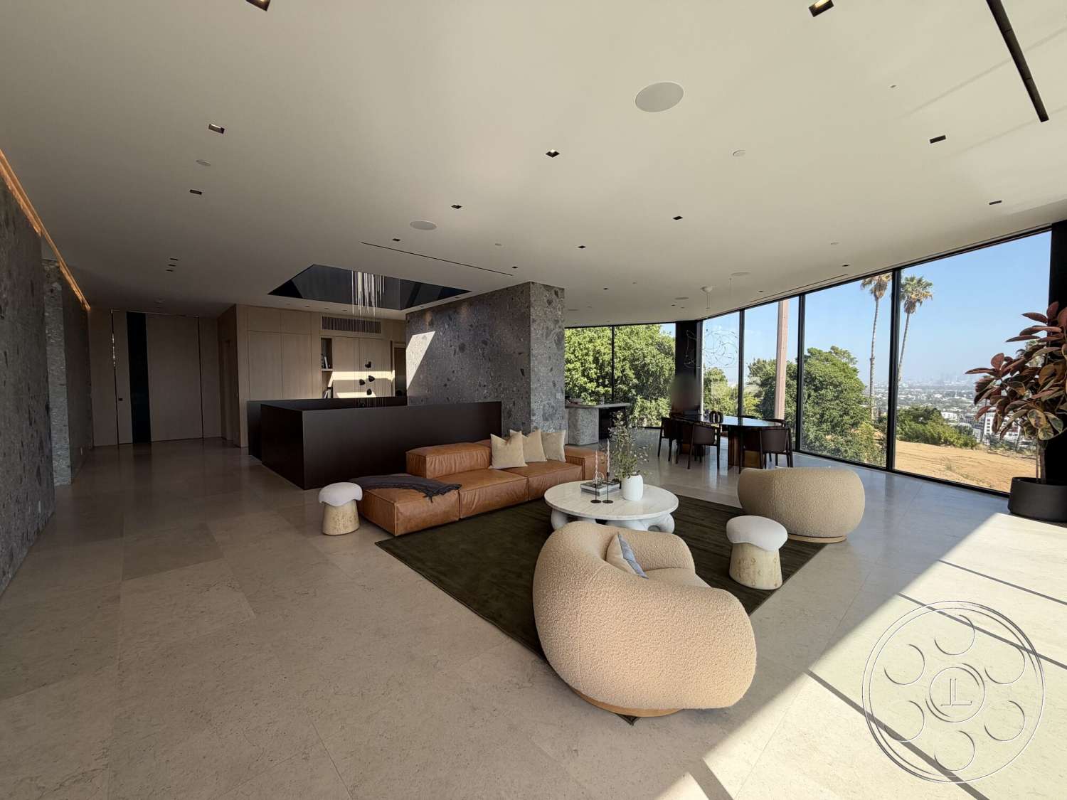 Modern 532 - neutral color palette, stone accent wall, open concept layout, interior space, light wood cabinetry, large floor-to-ceiling windows, plush area rug, contemporary dining area, leather sectional sofa, beige marble flooring, minimalist architectural style, modern round coffee table, glass roof skylight, panoramic landscape view
