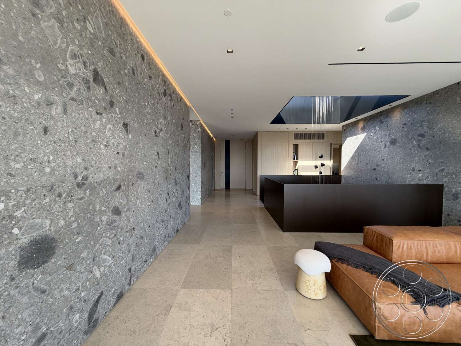 Modern 532 - neutral color palette, exterior, abundant natural light, light-colored stone flooring, minimalistic architecture, modern open floor plan, polished stone feature wall, dark wood kitchen island, large ceiling skylight, luxurious leather sectional sofa, white accent decor piece