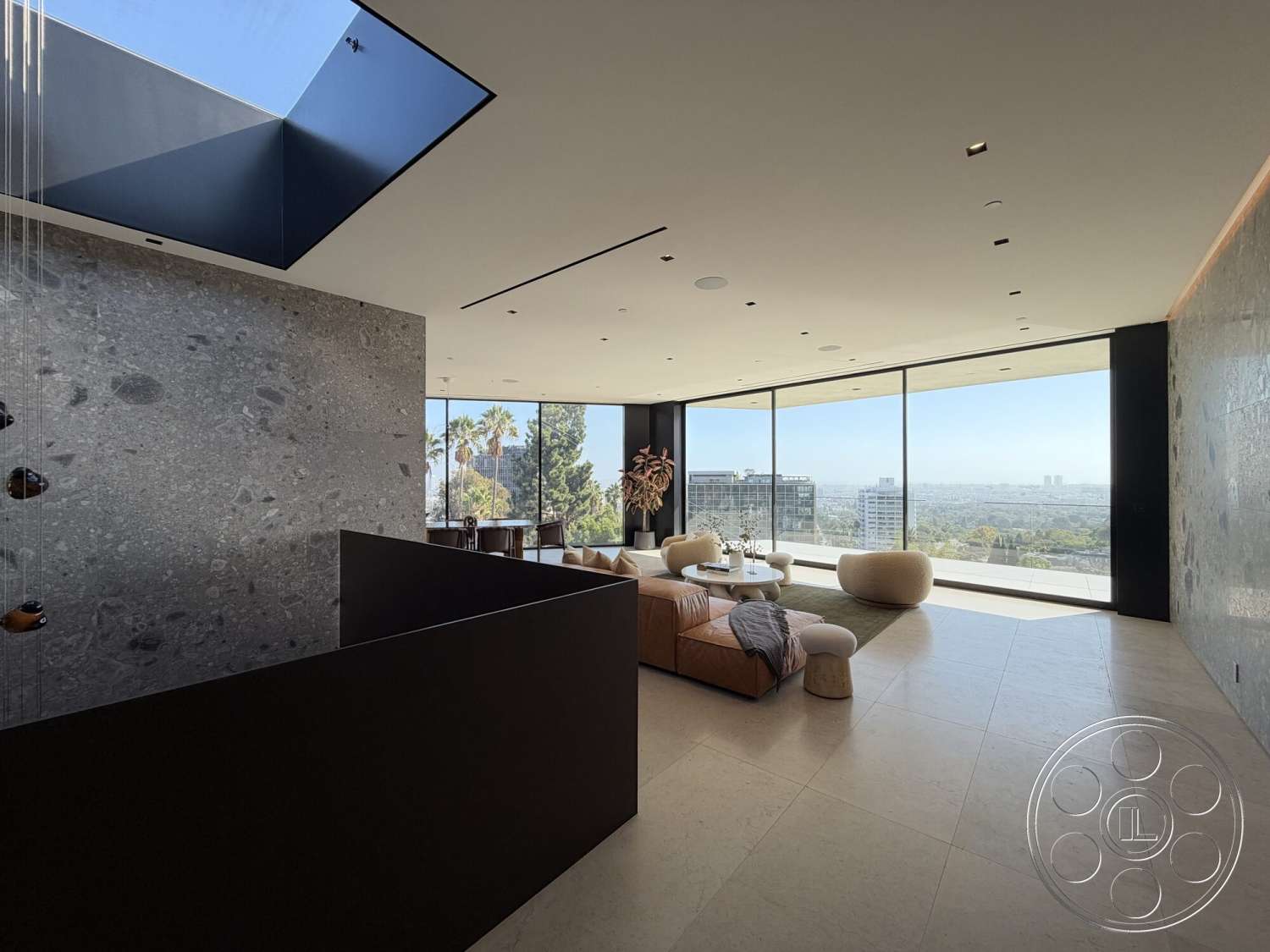 Modern 532 - neutral color palette, floor-to-ceiling windows, textured wall surface, open-concept living area, natural light-filled space, contemporary architectural design, modern minimalist furniture, urban landscape view, granitic stone feature wall, rectangular glass skylight, black lacquered cabinetry, cream-colored stone flooring, curved seating elements, elegant decor details