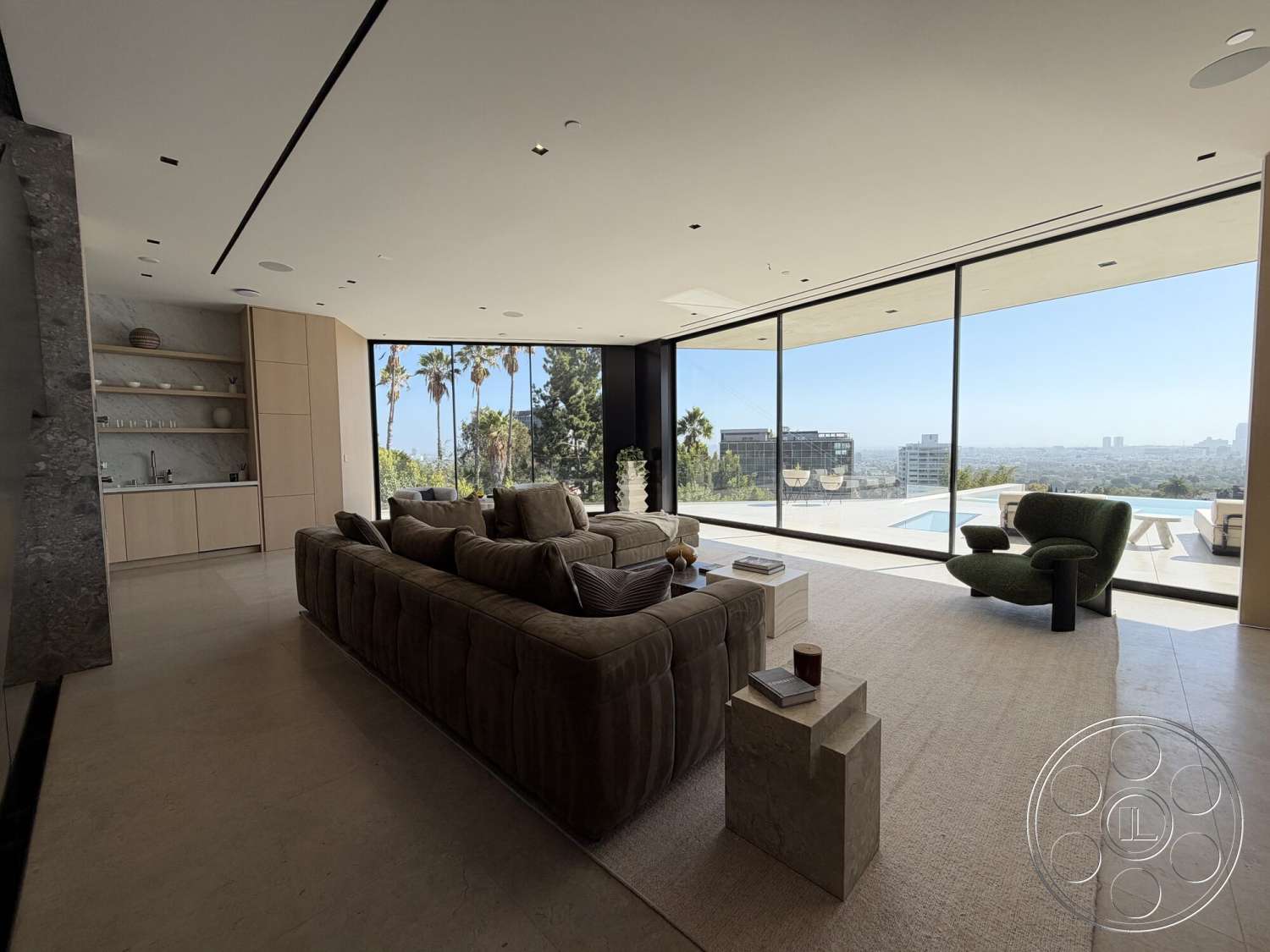 Modern 532 - neutral color palette, textured area rug, wood cabinetry, concrete flooring, floor-to-ceiling windows, city skyline view, modern sectional sofa, contemporary accent chair, open living area, minimalist shelving unit