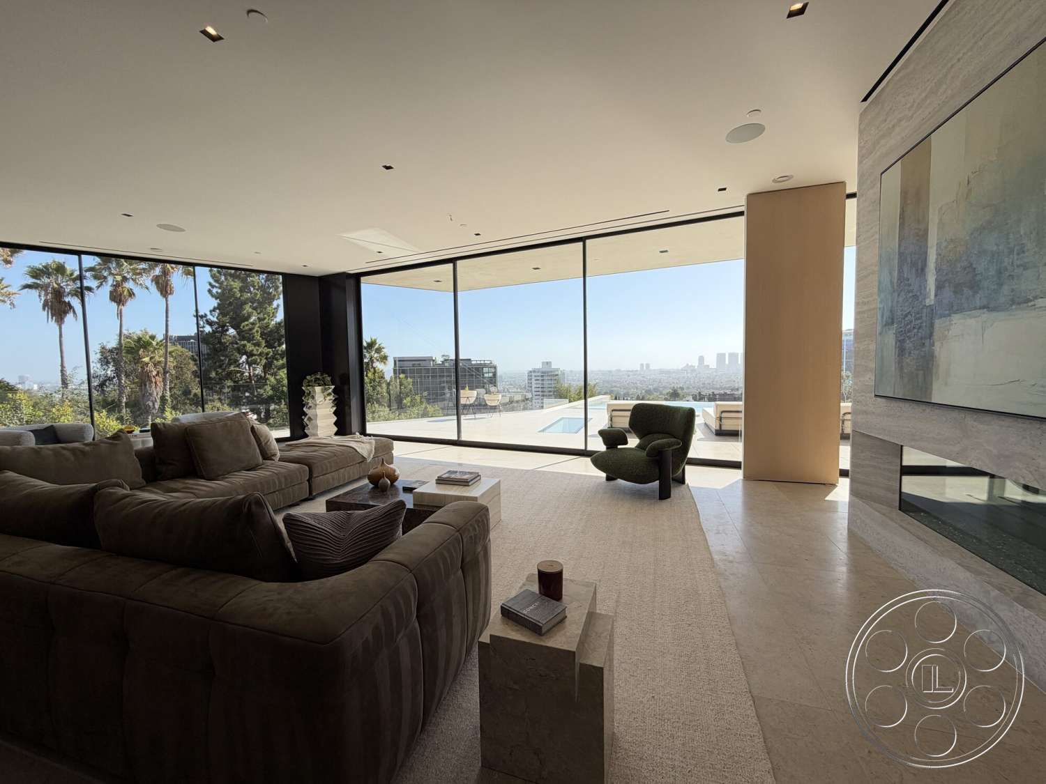 Modern 532 - neutral color palette, textured wall art, open floor plan, exposed concrete wall, floor-to-ceiling windows, polished marble flooring, minimalist coffee table, light beige area rug, green accent chair, contemporary sectional sofa, indoor-outdoor integration, natural light-filled living room, overlooking city skyline, lush palm trees visible through windows