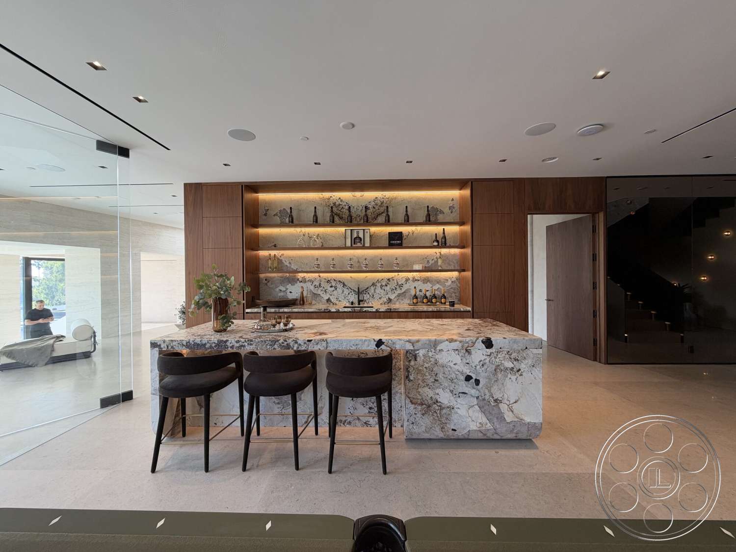Modern 532 - recessed lighting, soft neutral color palette, polished concrete floor, open floor plan, wood cabinetry, floor-to-ceiling windows, dark wood door, modern bar stools, glass partition walls, marble kitchen island, architectural stairway, minimalist wall shelving