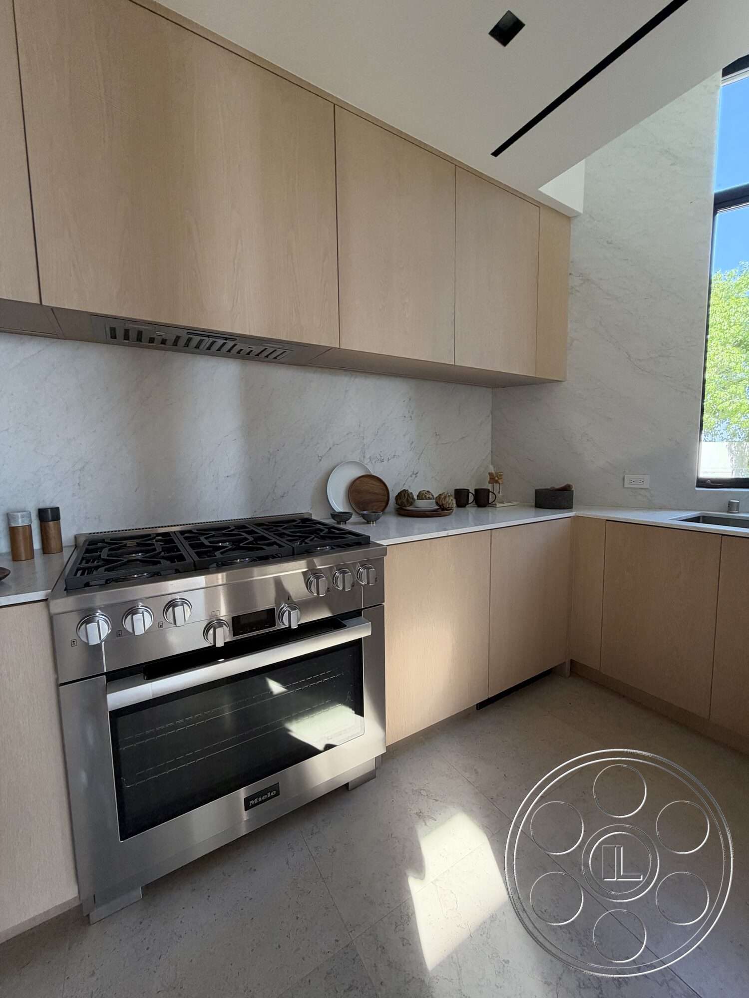 Modern 532 - quartz countertop, open concept layout, floor-to-ceiling windows, modern kitchen appliances, minimalist kitchen design, stainless steel gas range, marble kitchen backsplash, tile kitchen flooring, light wood kitchen cabinets