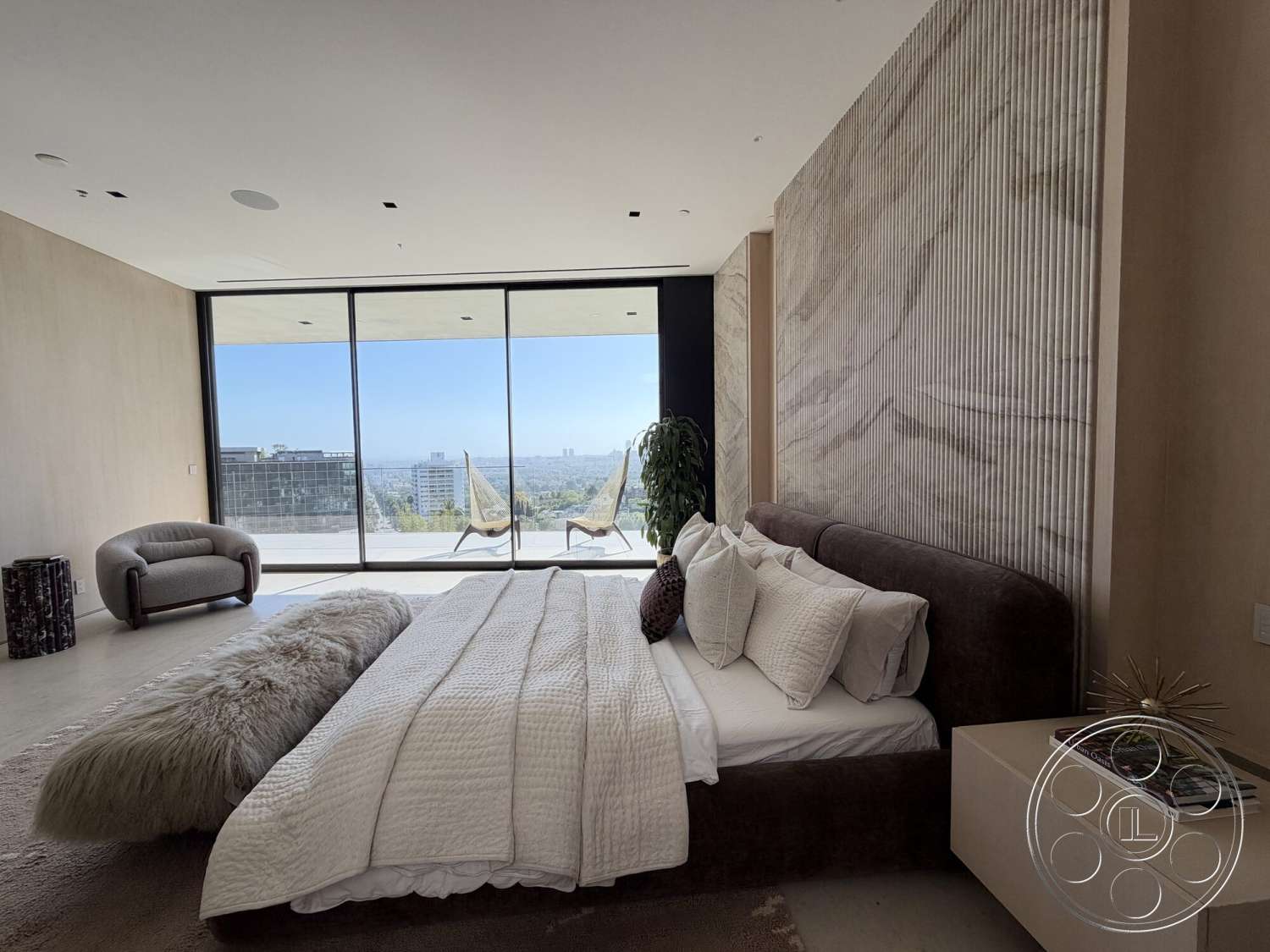 Modern 532 - king-size bed, concrete flooring, floor-to-ceiling windows, city skyline view, textured plaster walls, upholstered headboard, luxury bedding, minimalist nightstand, modern accent chair, tall indoor plant, striped decorative wall panel