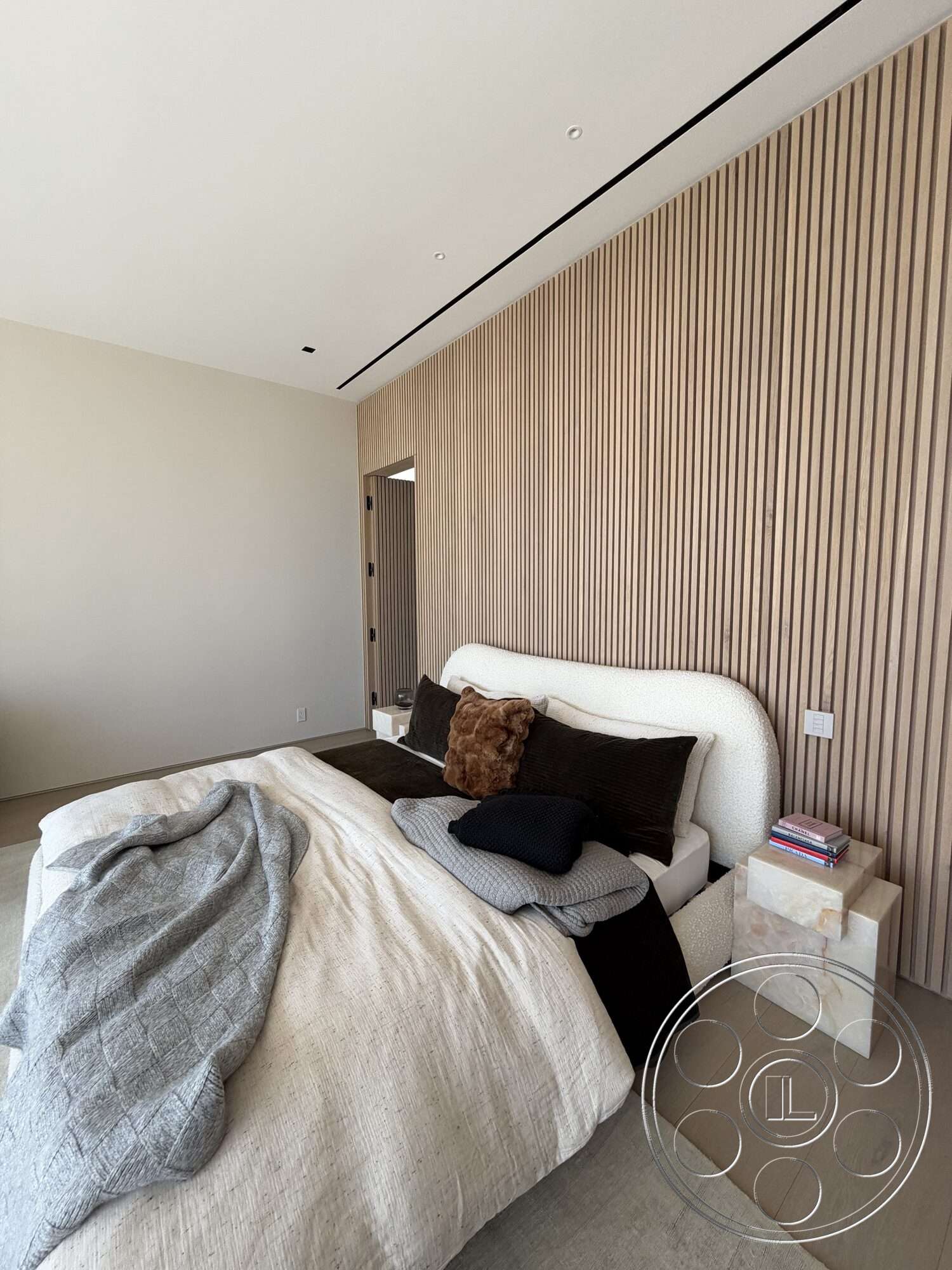 Modern 532 - minimalist design, decorative throw pillows, recessed lighting fixtures, light hardwood bedroom floors, textured fabric bed headboard, light wood paneling wall, neutral color bedding, concrete bedside table, soft wool blanket, modern bedroom style