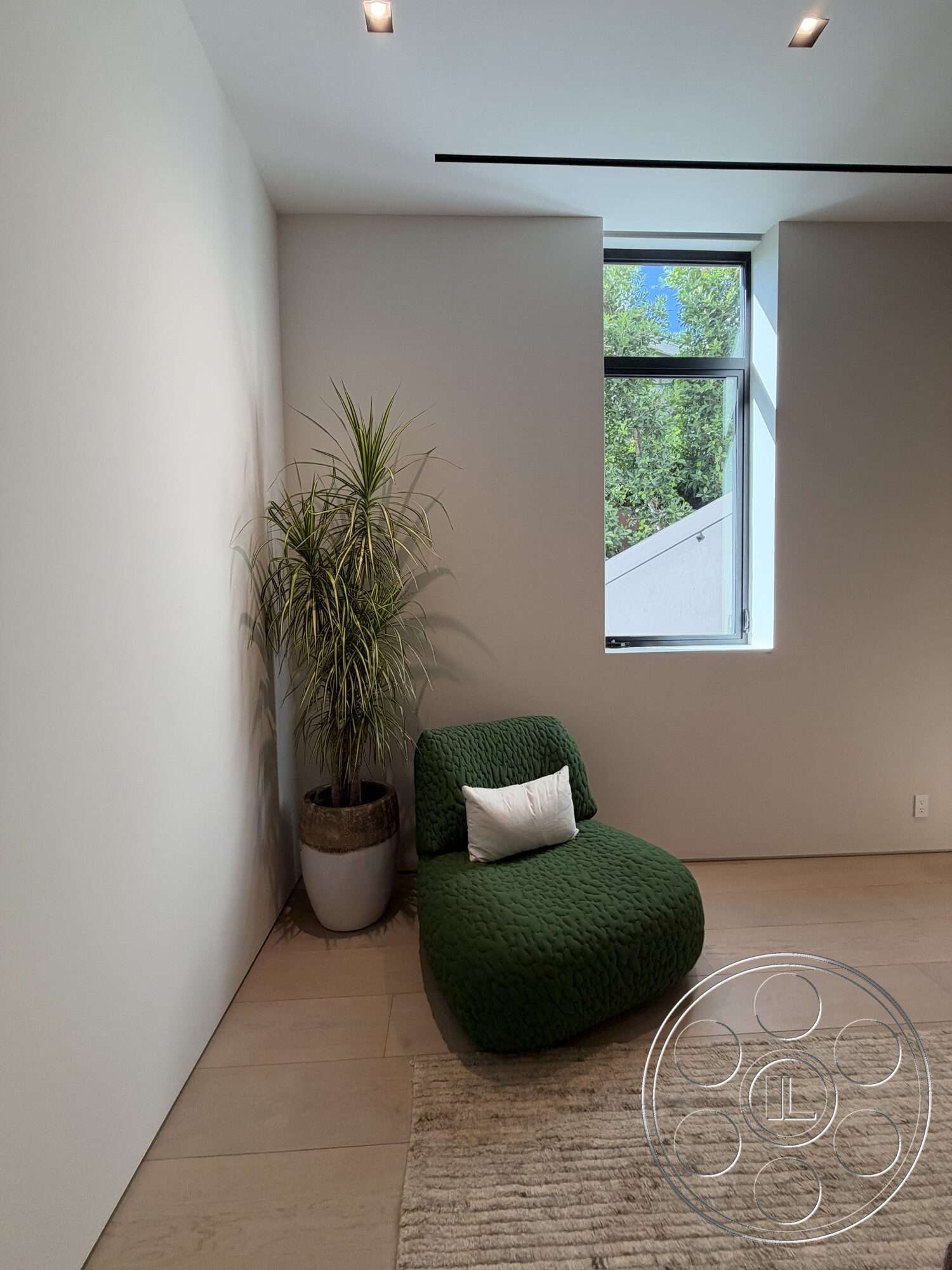 Modern 532 - minimalist decor, hardwood flooring, soft area rug, flush ceiling lights, modern lounge chair, neutral painted walls, potted indoor plant, rectangular window