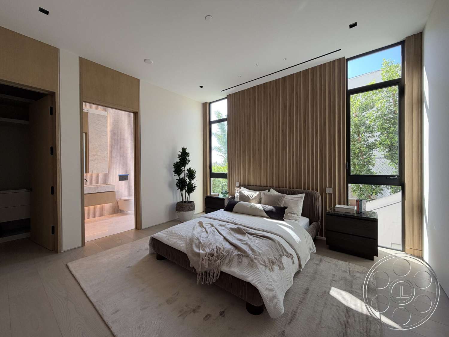 Modern 532 - soft natural lighting, large floor-to-ceiling windows, decorative throw pillows, plush area rug, neutral color scheme, interior bedroom, minimalist nightstand, modern upholstered bed, indoor plant decoration, light wood paneling wall, laminate closet doors, separate ensuite bathroom view
