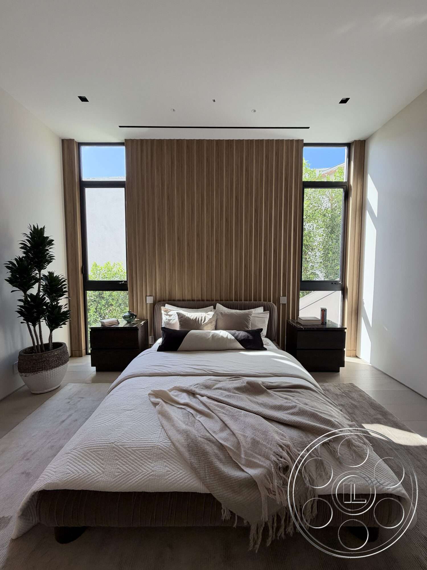 Modern 532 - natural light, minimalist design, textured area rug, light hardwood flooring, floor-to-ceiling windows, wood accent wall, horizontal wood paneling, plank ceiling, white painted walls, contemporary bedroom, potted indoor plant, neutral bedding, upholstered bed frame, nightstands with dark wood veneer, soft gray throw blanket