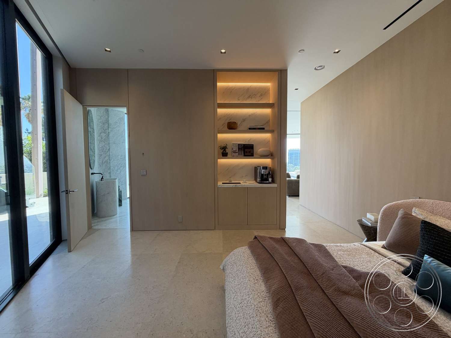Modern 532 - neutral color palette, recessed lighting, open layout, stone flooring, floor-to-ceiling windows, modern bedroom design, light wood paneling walls, textured stone bedroom floors, built-in cabinetry with marble accent, contemporary home aesthetic, plush bedding with accent pillows