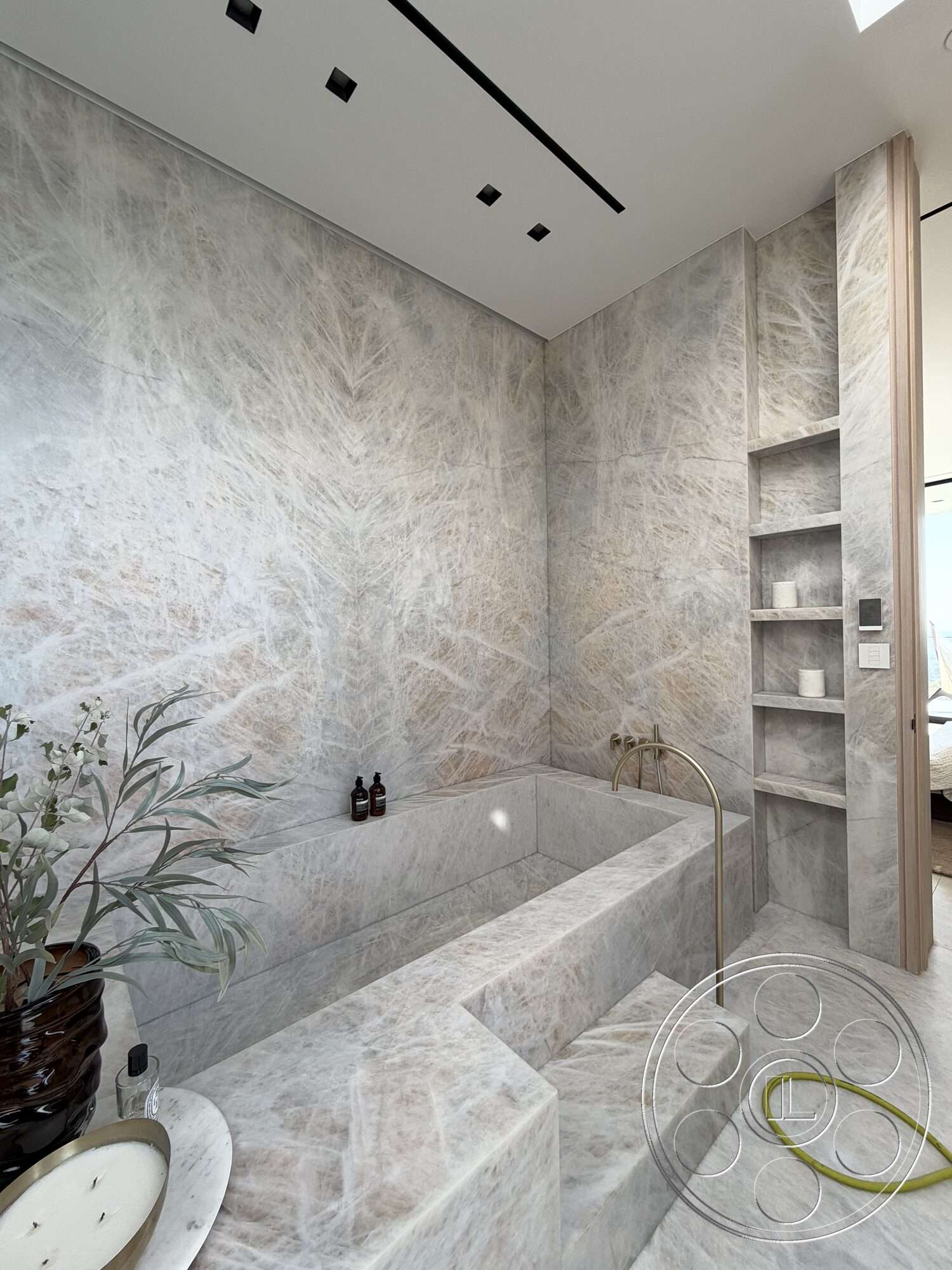 Modern 532 - neutral color palette, natural light, minimalist design, built-in shelving, marble flooring, contemporary bathroom, recessed ceiling lights, marble wall panels, marble bathtub, floating bathtub steps, textured marble