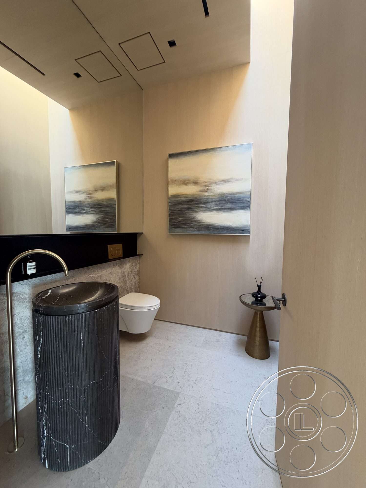 Modern 532 - minimalist decor, wood paneling, modern lighting fixtures, natural stone flooring, textured plaster walls, ambient natural light, black accent wall, gold metal accents, dark marble countertop, white ceramic toilet, artistic wall artwork, round marble sink pedestal, simple circular table