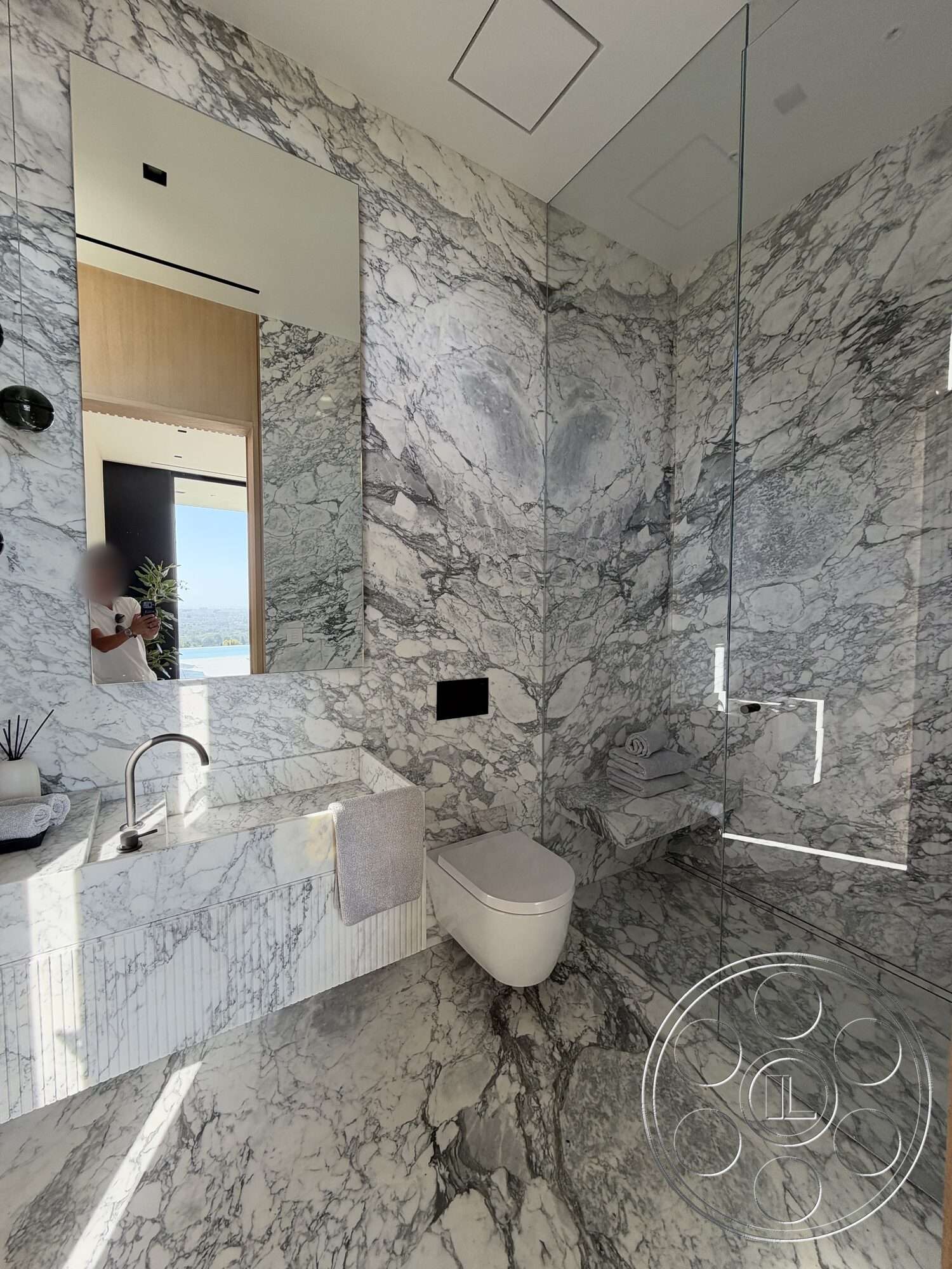 Modern 532 - glass shower enclosure, large mirror, floating vanity, modern fixtures, marble flooring, minimalist bathroom design, marble bathroom walls, marble vanity countertop, minimalist toilet, linear drain