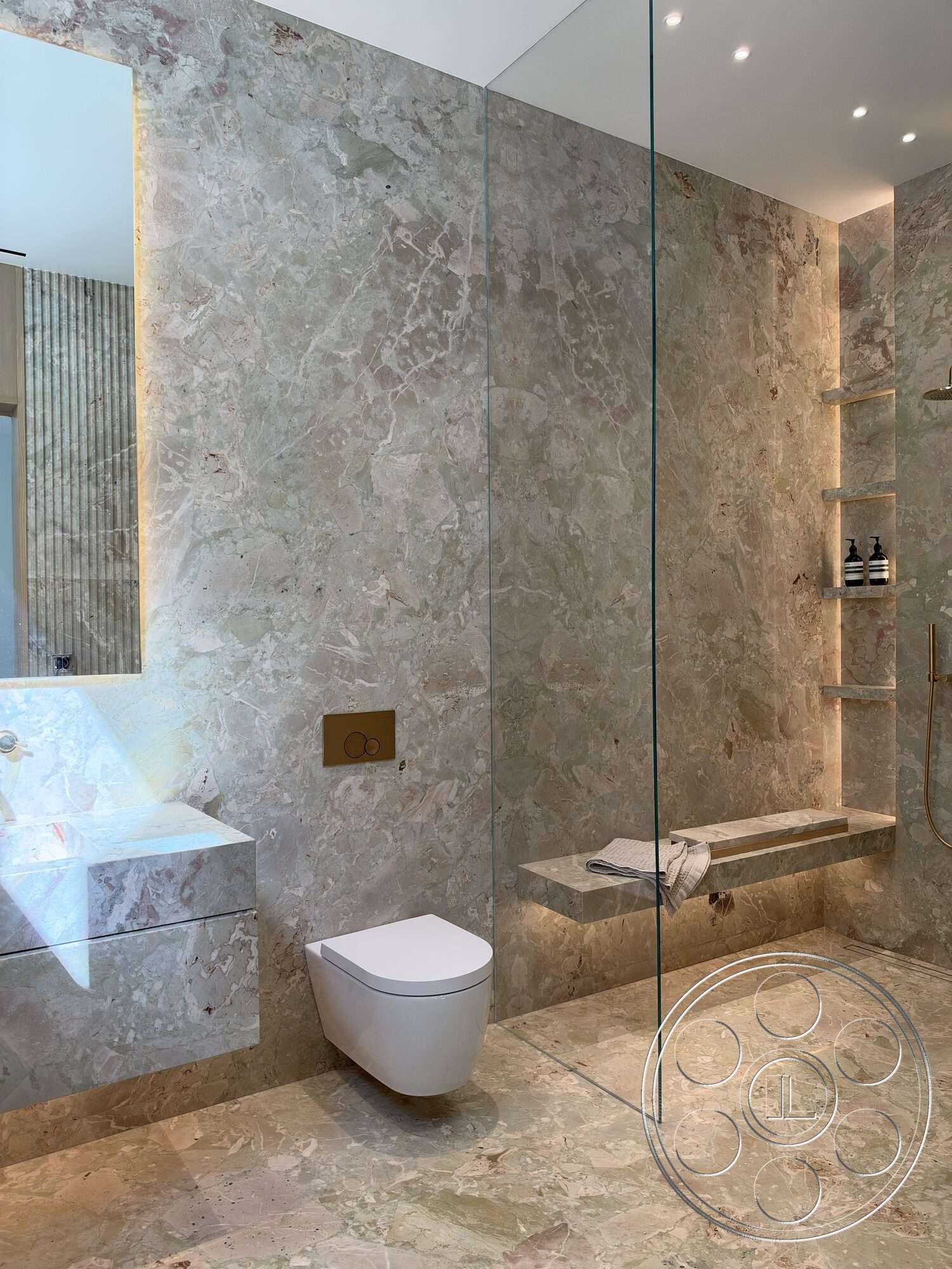 Modern 532 - recessed lighting, glass shower enclosure, wood accent wall, marble bathroom flooring, floating bathroom vanity, marble bathroom wall, brushed gold fixtures, minimalist toilet design, built-in shower bench