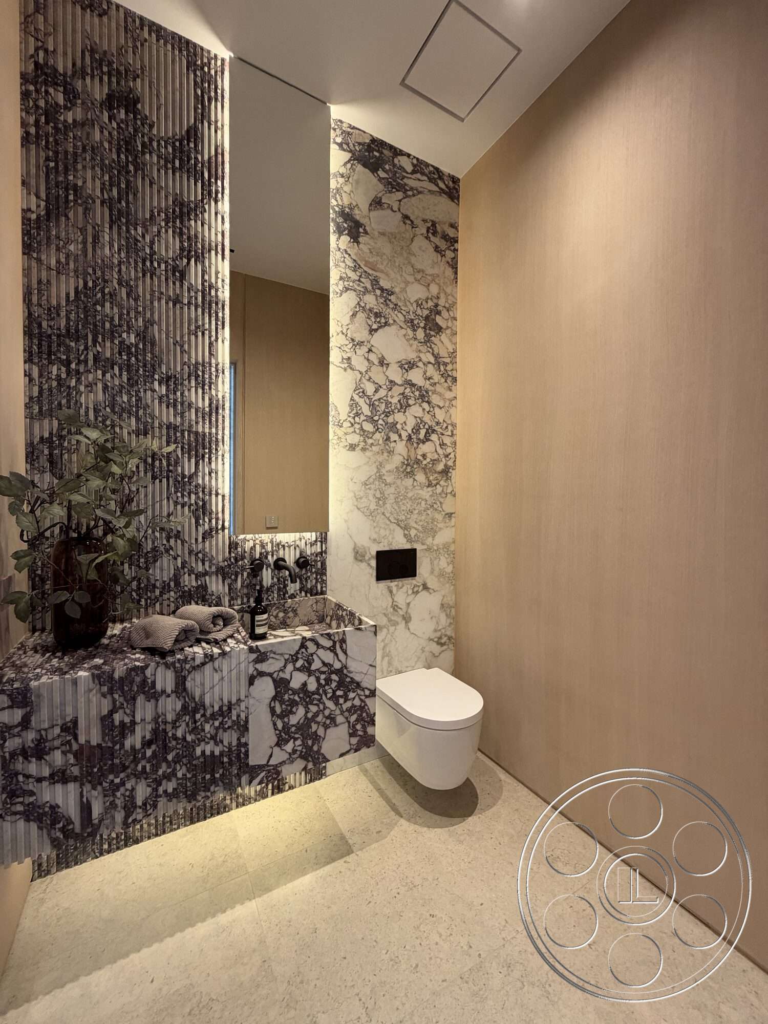 Modern 532 - neutral color palette, natural wood paneling, modern bathroom design, porcelain tile flooring, minimalist toilet design, textured marble bathroom walls, smooth marble sink countertop, horizontal striped marble backsplash, vanity with built-in sink, wall-mounted faucet fixtures
