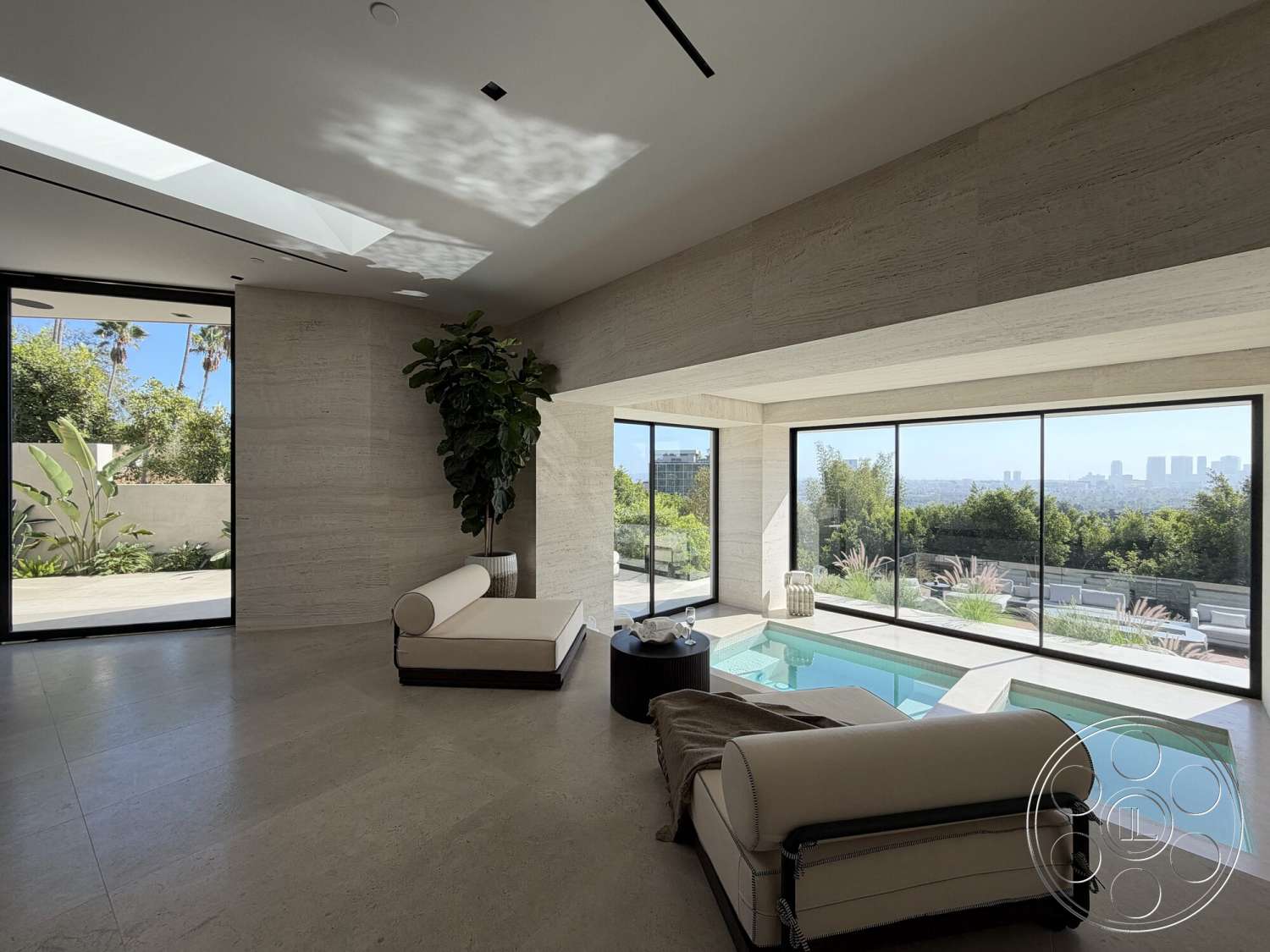 Modern 532 - large glass sliding doors, modern coffee table, floor-to-ceiling windows, soothing color palette, open living space, natural stone wall treatment, minimalist contemporary design, indoor plant feature, travertine floor tiles, skylights providing natural light, plush lounge chair, pool area with modern design, views of urban skyline, green landscaped surroundings