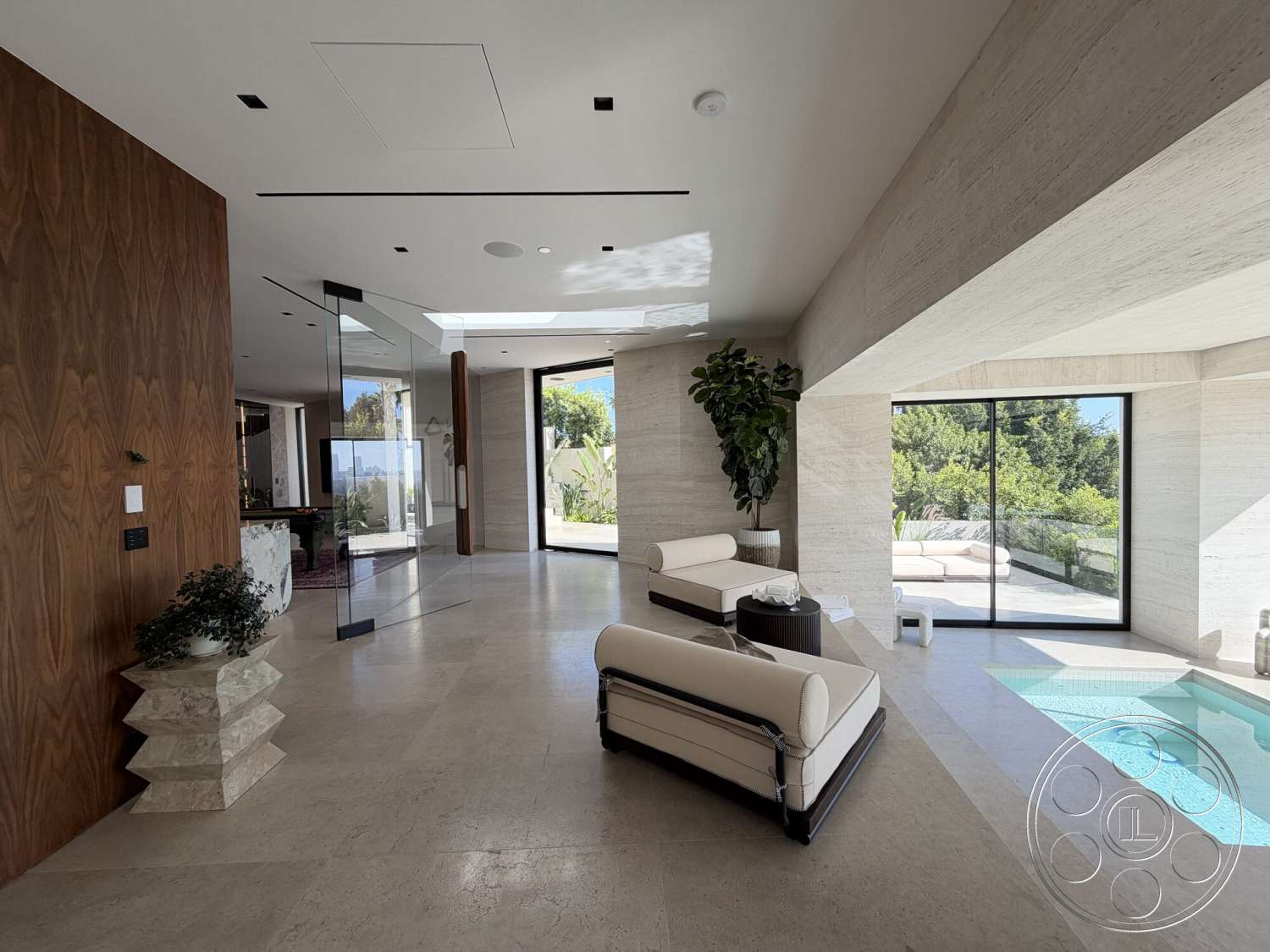 Modern 532 - minimalist decor, neutral color palette, natural light, open floor plan, sliding glass doors, floor-to-ceiling windows, dark wood accent wall, infinity edge pool, potted indoor plants, glass wall partition, modern lounge seating, contemporary ceiling design, architectural lighting fixtures, travertine flooring