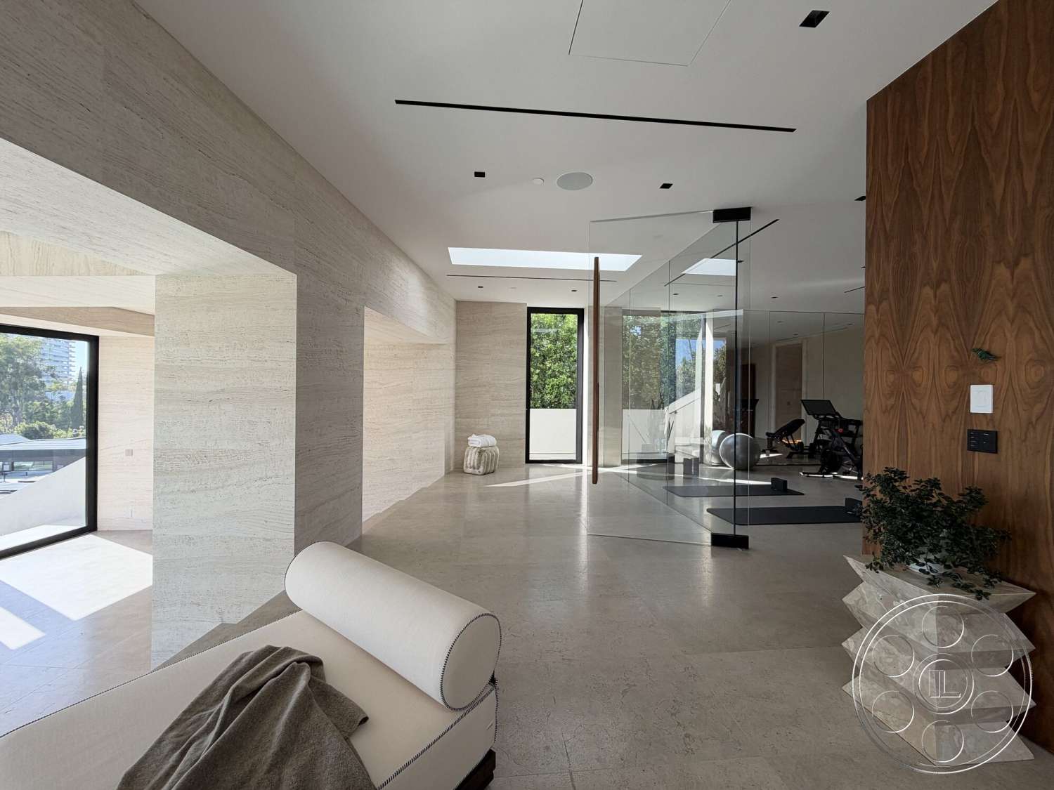 Modern 532 - neutral color palette, minimalist design, open floor plan, concrete flooring, modern architectural style, textured plaster walls, glass partition walls, expansive glass windows, wood veneer walls, skylight features, decorative stone sculpture