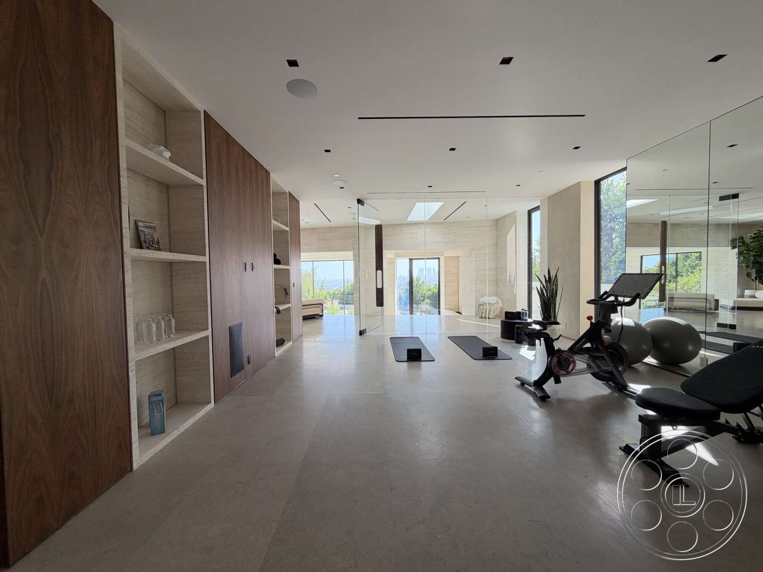 Modern 532 - neutral color palette, floor-to-ceiling windows, vaulted ceiling, open concept space, contemporary lighting fixtures, glass wall partitions, minimalist design aesthetic, built-in shelving units, wood paneling accent wall, natural light infusion, modern gym area, planted greenery accents, travertine flooring, rectangular yoga mats, state-of-the-art fitness equipment