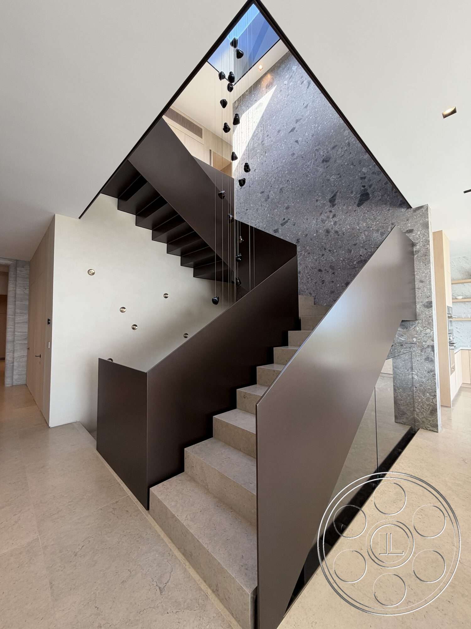Modern 532 - textured stone wall, exposed ceiling, modern staircase, minimalist architectural style, open atrium design, floating concrete steps, dark metal railing, floor-to-ceiling glass panel