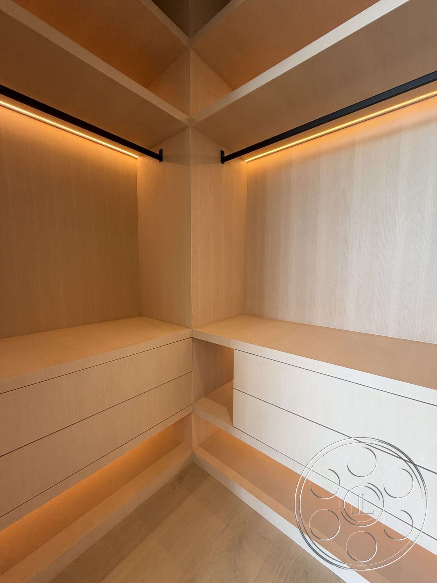 Modern 532 - light wood shelving, modern minimalist style, ambient LED lighting, light wood storage drawers, black metal hanging rods, corner closet design