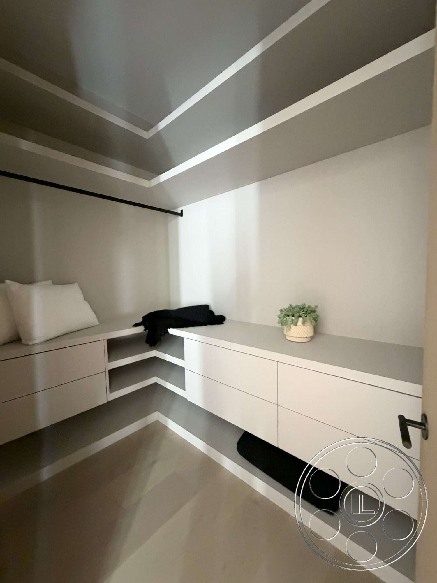 Modern 532 - minimalist design, floating shelves, polished concrete flooring, decorative plant, white cabinetry, soft cushions, corner seating area, interior closet space, light gray drywall, built-in drawers