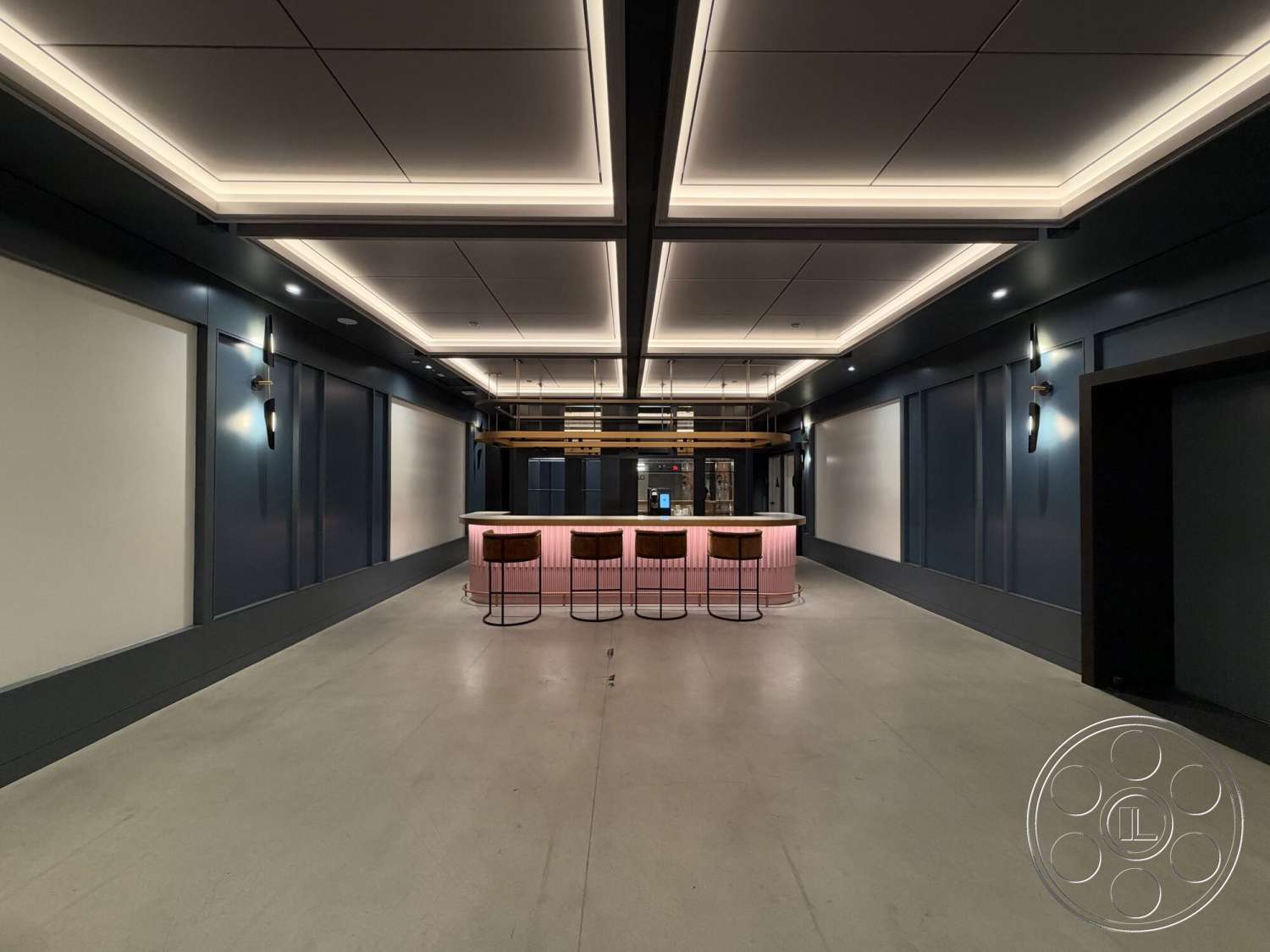 Office 130 - polished concrete flooring, modern light fixtures, wall sconces, metal bar stools, LED recessed lighting, coffered ceiling design, dark blue wall panels, wood frame bar, pink bar countertop, framed wall sections
