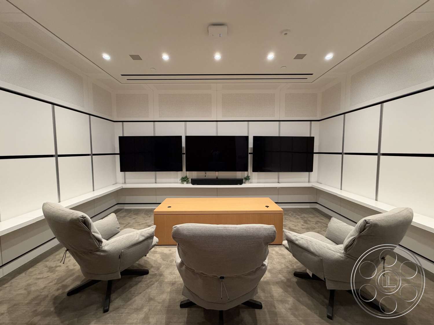 Office 130 - minimalist design elements, modern lounge chairs, acoustic ceiling panels, integrated lighting fixtures, wood conference table, white panel walls, fiber carpet flooring, wall-mounted flat-screen televisions, stylish shelf area