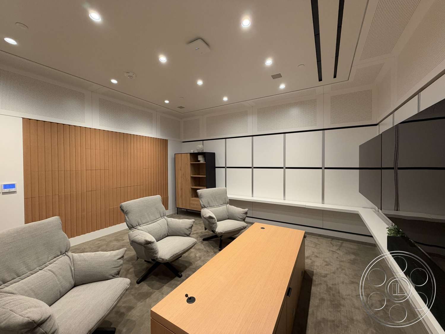 Office 130 - neutral color palette, open floor plan, carpet flooring, minimalist desk, textured wall paneling, wood accent wall, recessed ceiling lights, modern lounge chairs, acoustic ceiling treatment, plywood built-in shelving, flat-panel TV wall