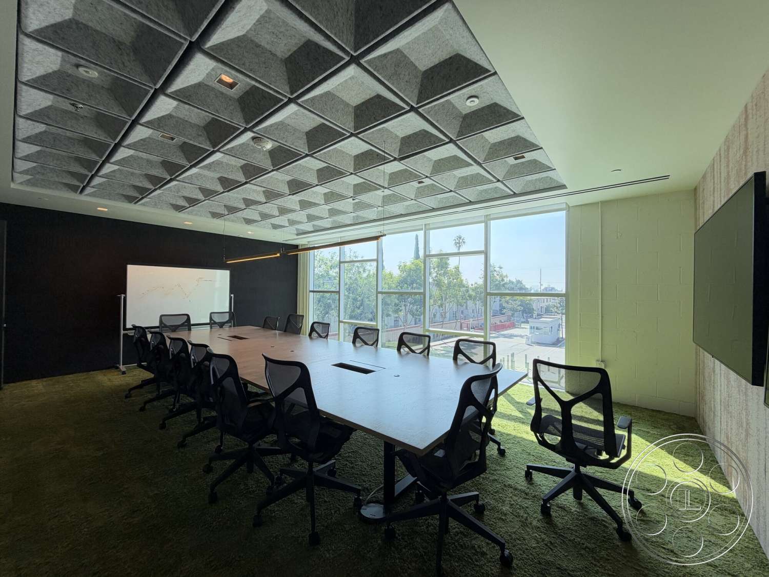 Office 130 - textured wall finish, floor-to-ceiling windows, carpeted flooring, black accent wall, acoustic ceiling panels, LED recessed lighting, interior conference room, wood conference table, whiteboard wall, mesh office chairs