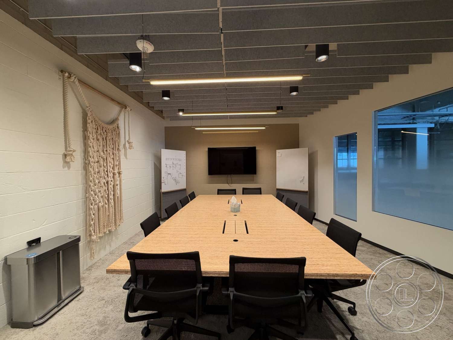 Office 130 - textured wall art, concrete flooring, linear light fixtures, glass partition walls, modern office design, wood conference table, whiteboard wall, black ergonomic office chairs, exposed ceiling with acoustic panels, flat screen TV wall-mounted, ambient track lighting