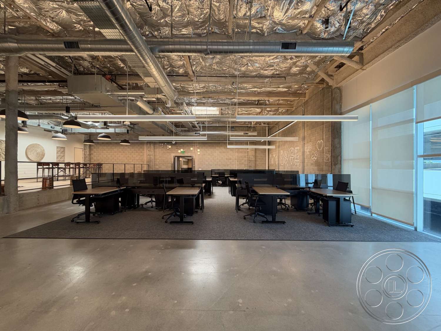 Office 130 - polished concrete flooring, minimalist design elements, exposed concrete walls, open office layout, acoustic ceiling tiles, glass office partition, contemporary office interior, suspended metal ductwork, pendant industrial lighting, rectangular workstations