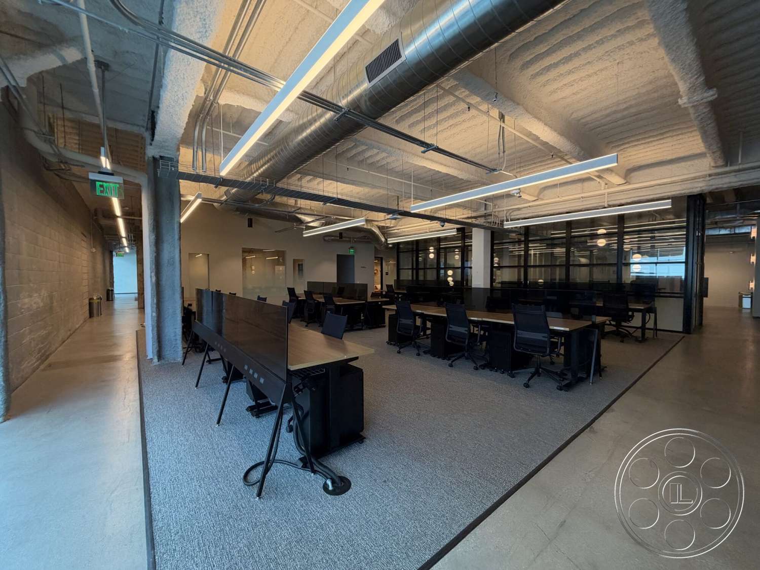Office 130 - polished concrete flooring, exposed concrete walls, ergonomic office chairs, glass partition walls, steel support beams, interior office space, carpet office flooring, open workspace layout, rectangular conference tables, industrial style lighting fixtures, suspended ceiling with acoustic tiles, modern suspended linear lighting
