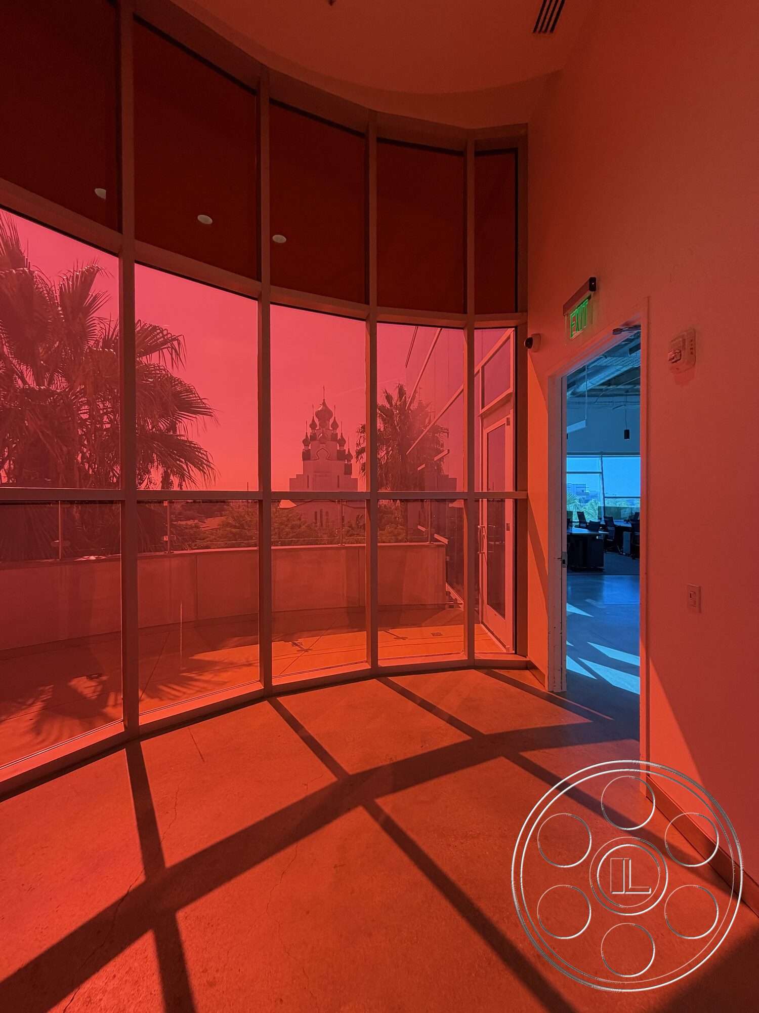 Office 130 - natural light, concrete flooring, floor-to-ceiling windows, modern architectural style, panoramic city view, decorative shadows, open-plan layout, suspended ceiling details, curved glass walls