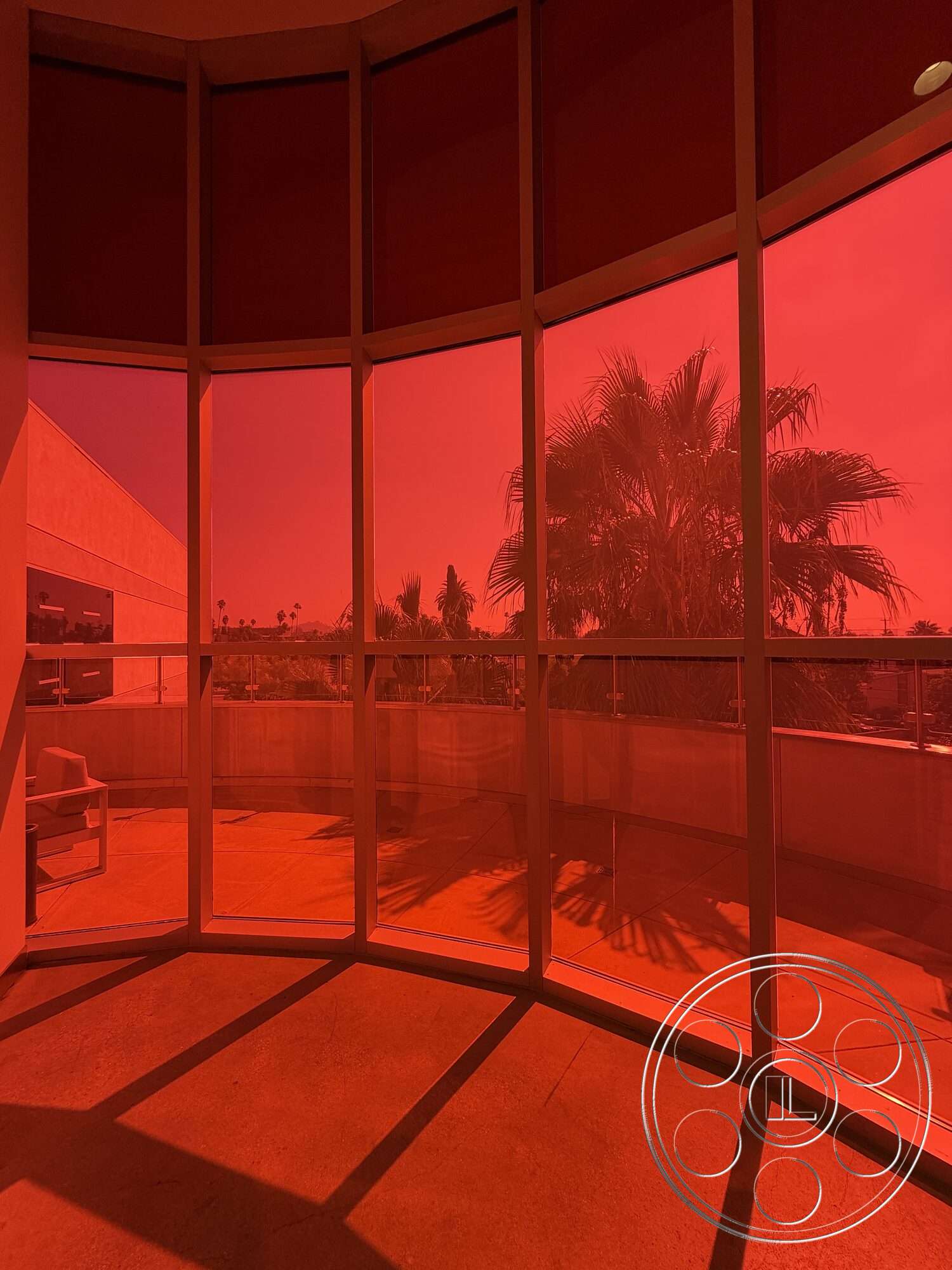 Office 130 - contemporary design, modern architecture, open floor plan, floor-to-ceiling windows, outdoor view, concrete balcony floor, curved glass wall, red tinted glass, spacious indoor space